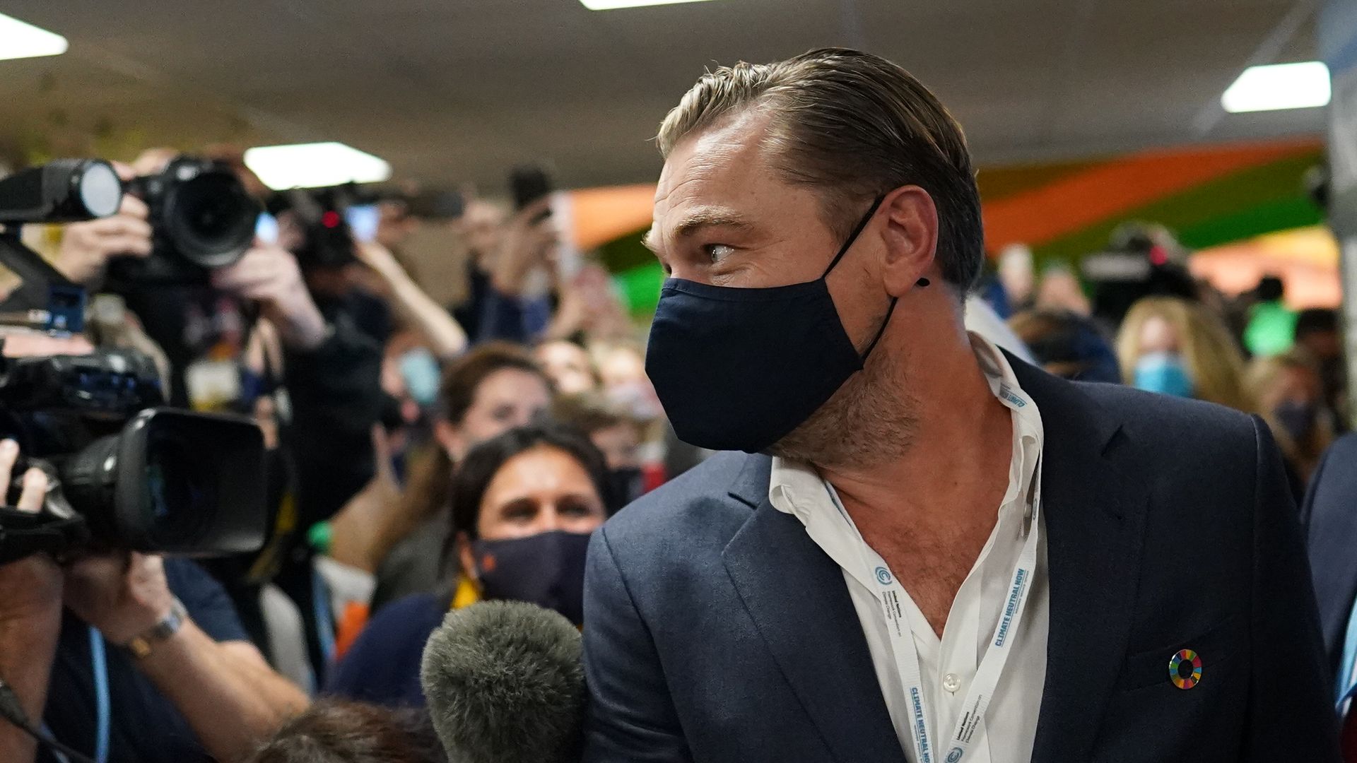 Leonardo DiCaprio stands in front of a group of photographers at the COP26 climate summit