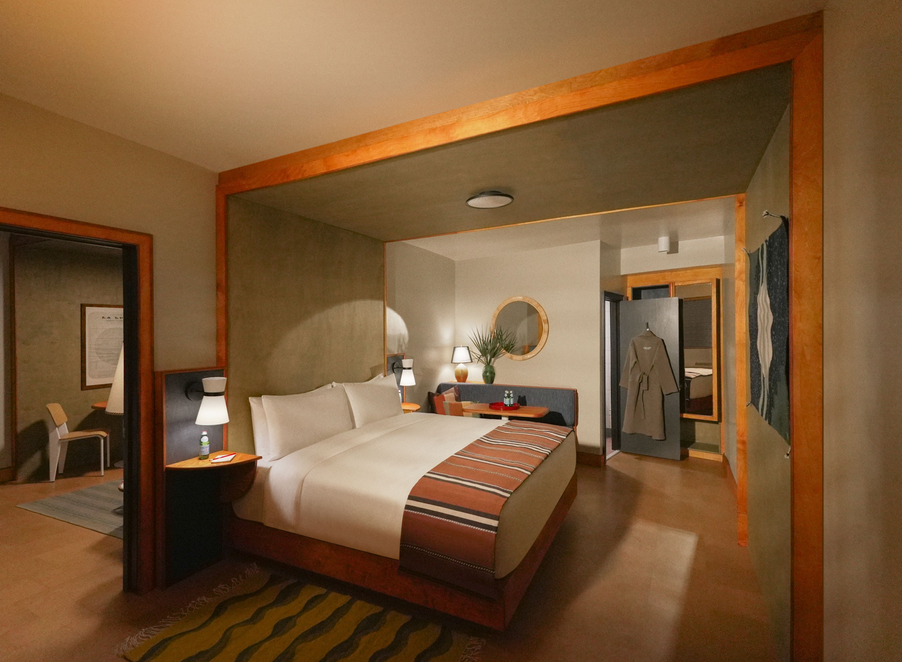 A warm-toned hotel room with wooden beams and a made made. A robe hangs from an open door near the back.