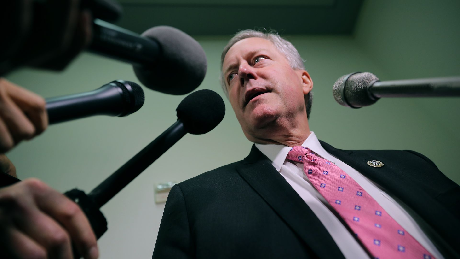 Mark Meadows speaks into a gaggle of press microphones.