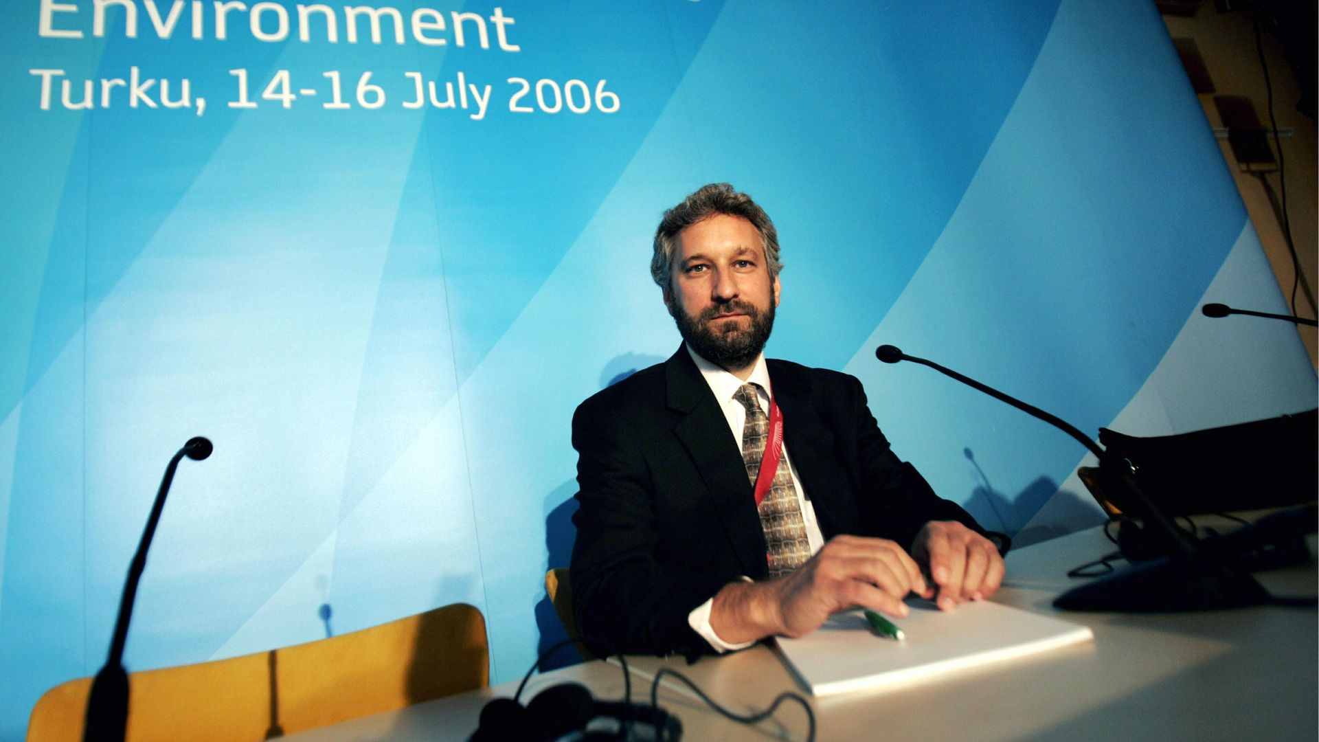 Elliot Diringer sitting at a table with a microphone.