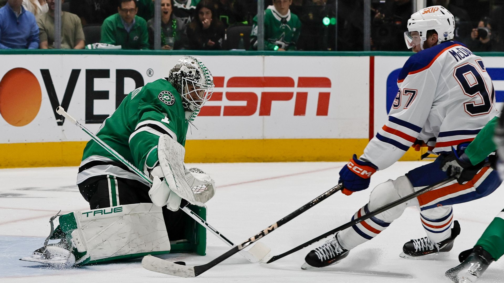Dallas Stars goalie Casey DeSmith tries to stop Edmonton Oiler Connor McDavid at the goal 