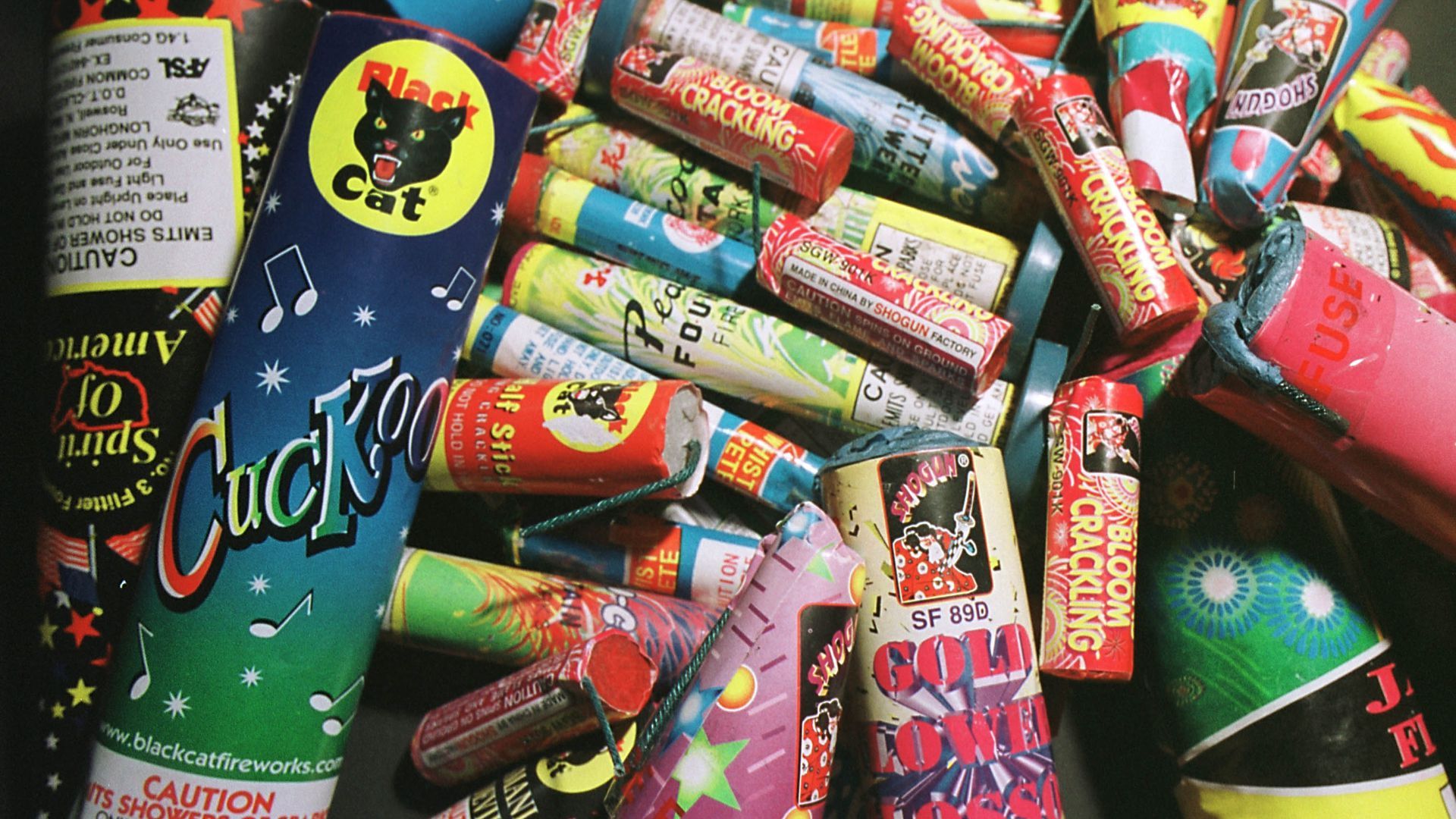 Dozens of colorful bottle rocket fireworks for sale.