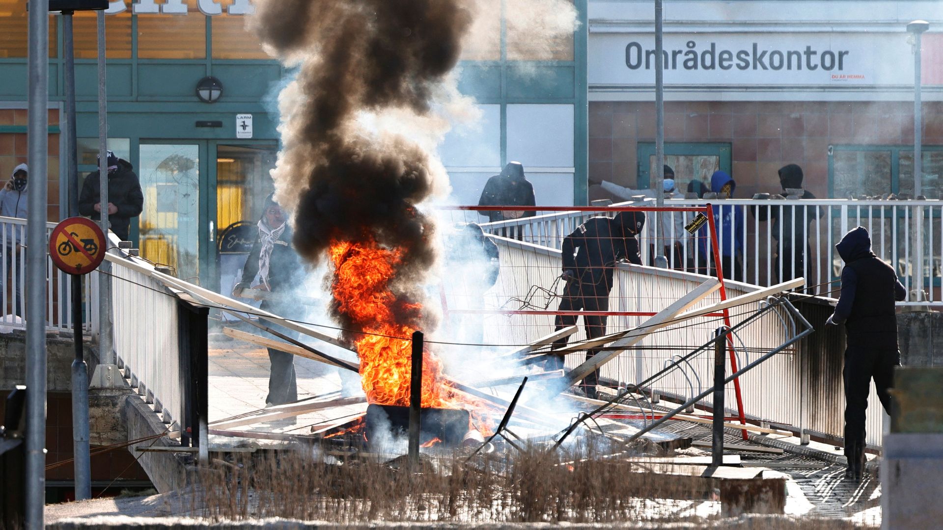  Protesters burn a barricade at the entrance to a shopping center during rioting in Norrkoping, Sweden on April 17.