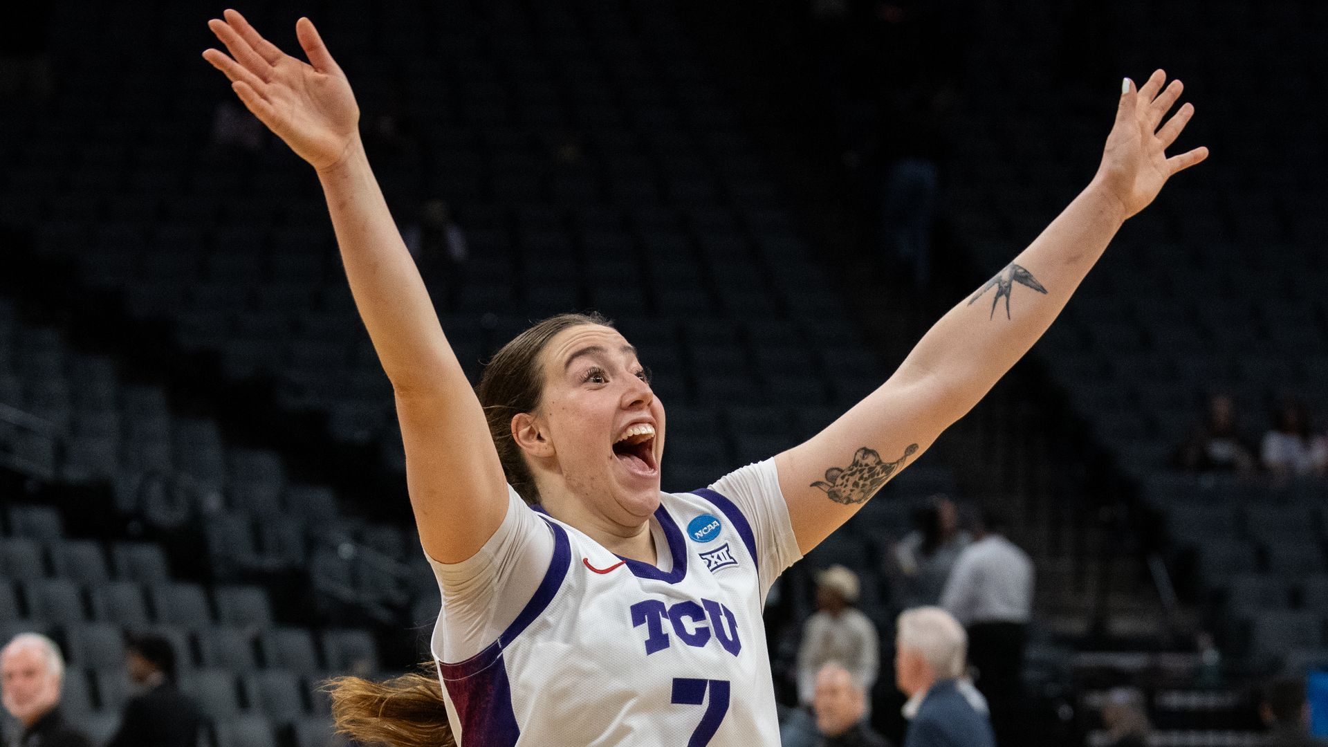 TCU women's basketball player Marta Suárez smiles and has her arms in the air celebrating after the Horned Frogs beat University of Virginia in the Sweet Sixteen of the 2026 NCAA Women's Basketball Tournament. 