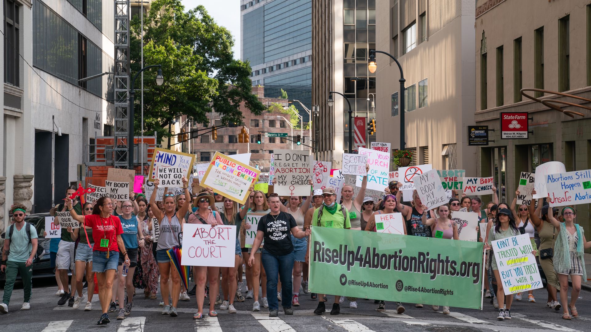 People march in the street during a protest against the Supreme Court's ruling in the Dobbs v Jackson Women's Health Organization on June 25, 2022 in Atlanta, Georgia.
