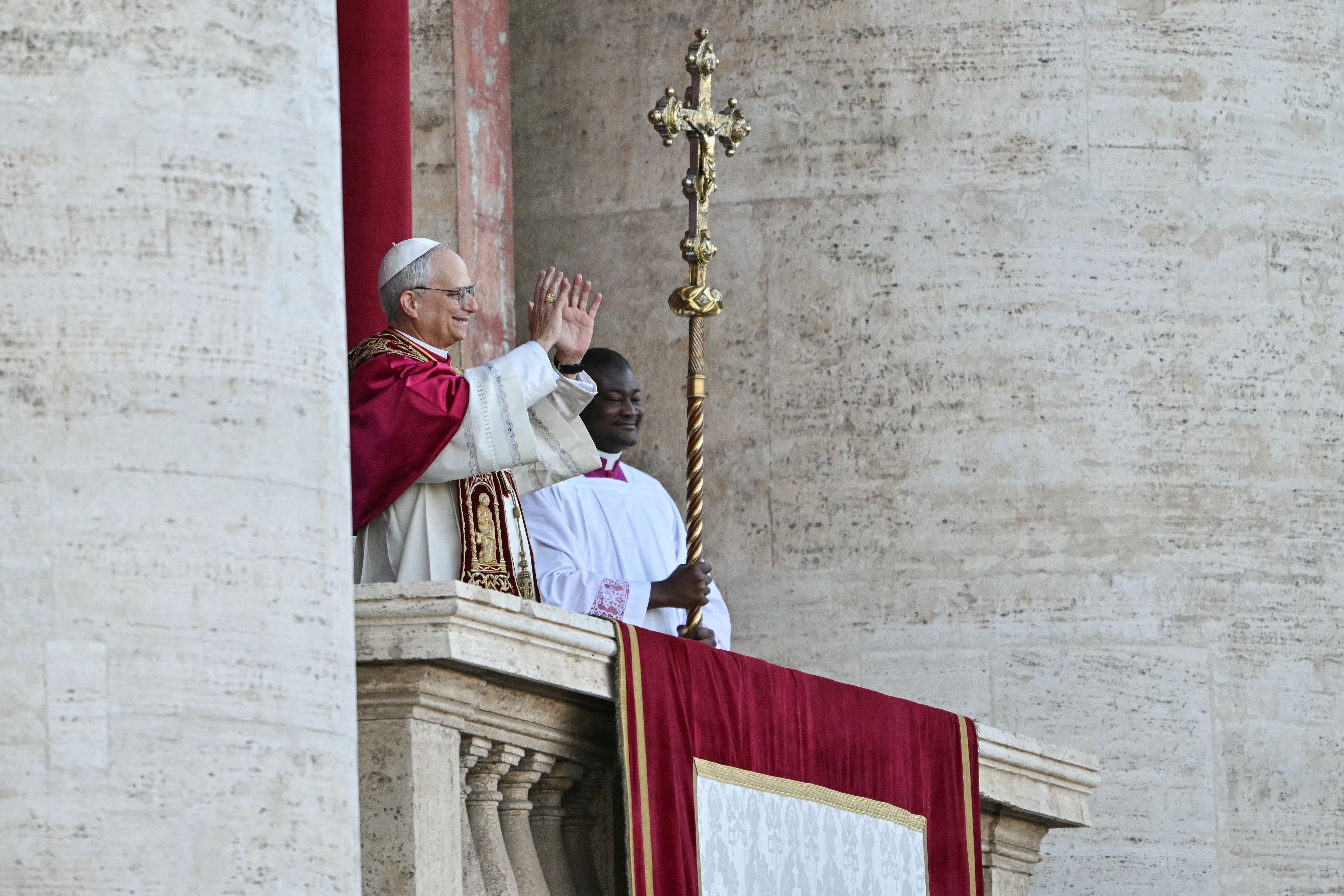 Newly elected Pope Leo XIV, Robert Francis Prevost (L) gestures on the main central loggia balcony of the St Peter's Basilica, after the cardinals ended the conclave, in The Vatican, on May 8, 2025. Robert Francis Prevost was on Thursday elected the first pope from the United States