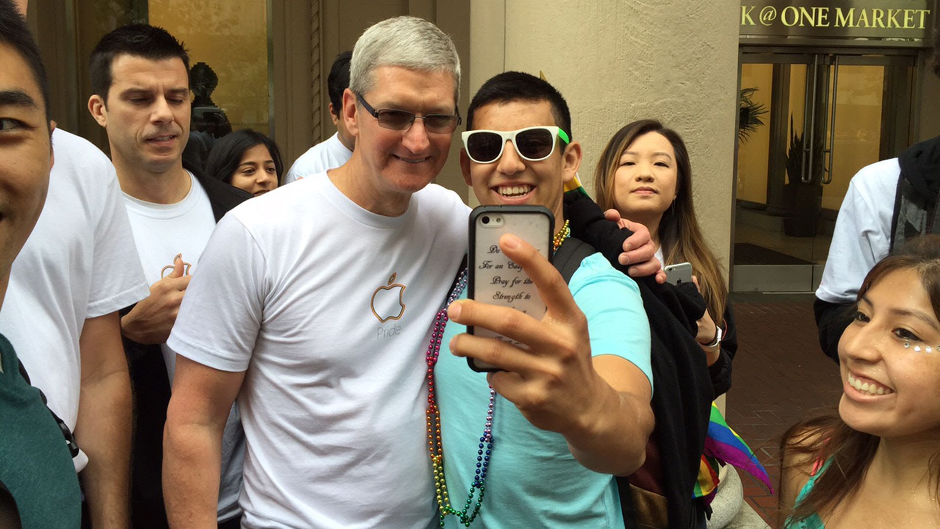 Apple CEO Tim Cook poses for a selfie with a group of teenagers