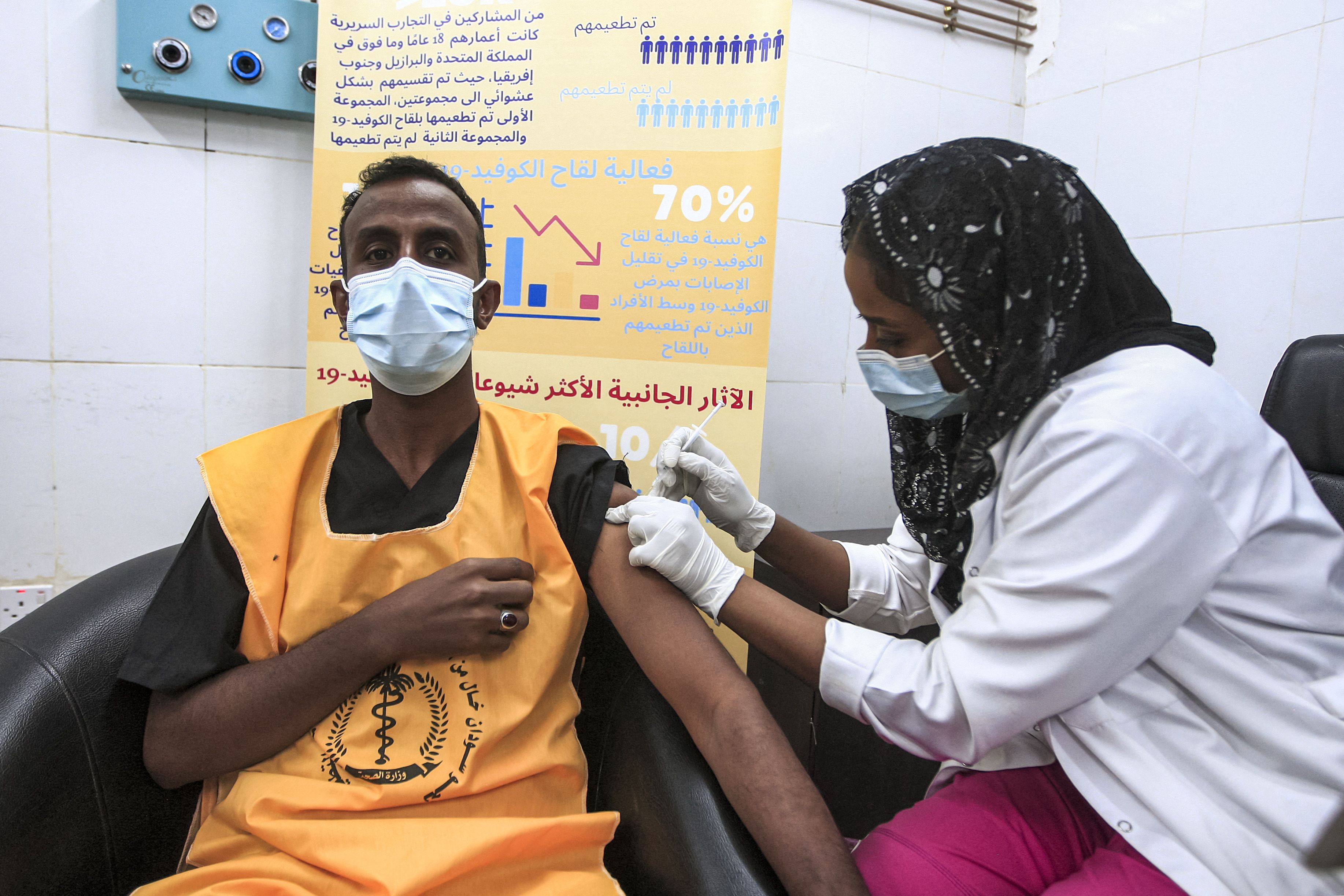 A medical worker receives a dose of the Oxford-AstraZeneca COVID-19 coronavirus vaccine at the Jabra Hospital for Emergency and Injuries in Sudan's capital Khartoum on March 9