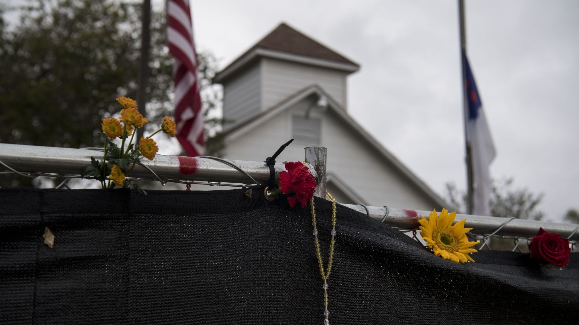 A rosary hangs on the fence surrounding the Sutherland Springs First Baptist Church one week after 26 people were killed inside in Sutherland Springs, Texas on November 12, 2017. 