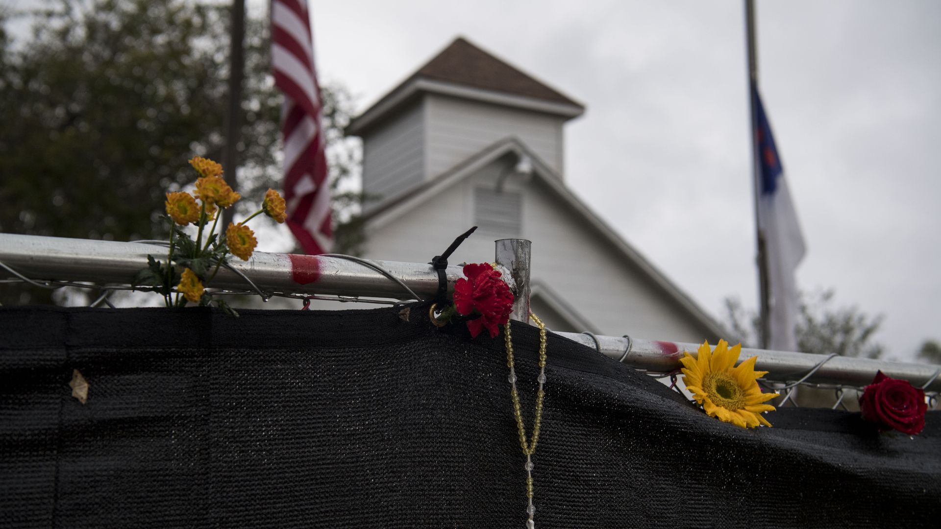 A rosary hangs on the fence surrounding the Sutherland Springs First Baptist Church one week after 26 people were killed inside in Sutherland Springs, Texas on November 12, 2017.