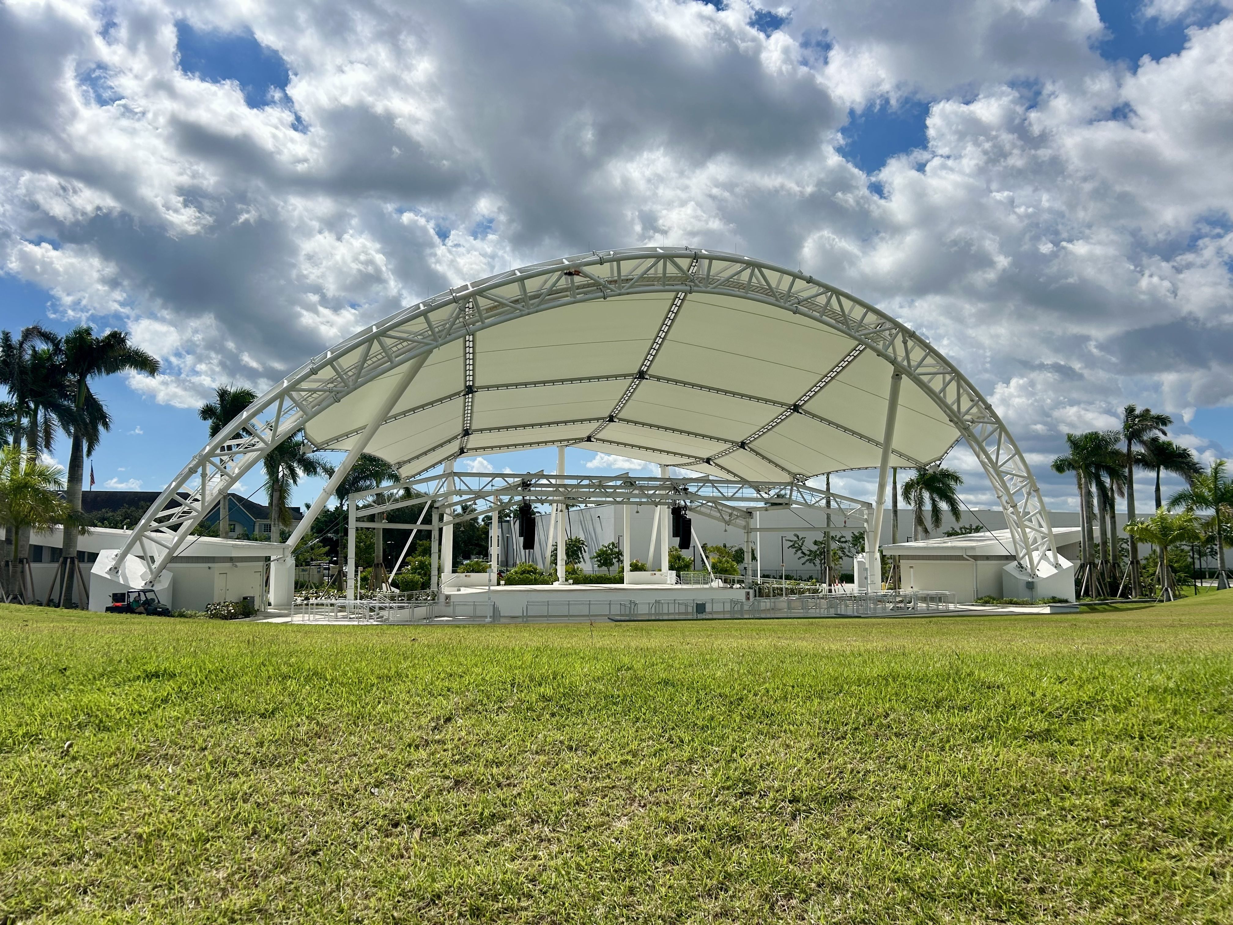Large grass area in front of an amphitheater. 