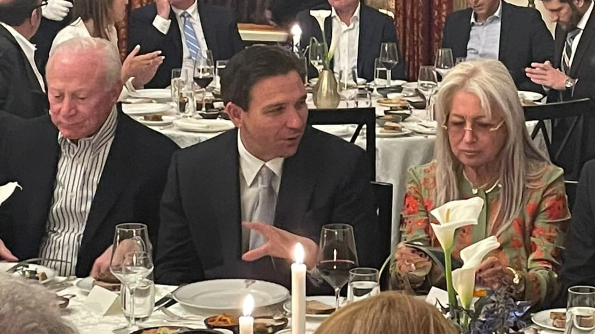Florida Gov. Ron DeSantis sits between Miriam Adelson and Larry Mizel at a dinner in Jerusalem. Photo obtained by Axios.