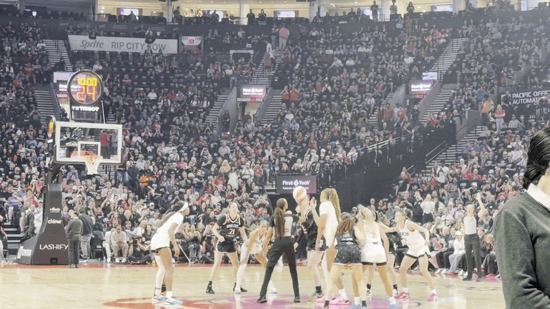 Animated gif shows the opening tipoff of the Portland Fire's first game from the sideline.