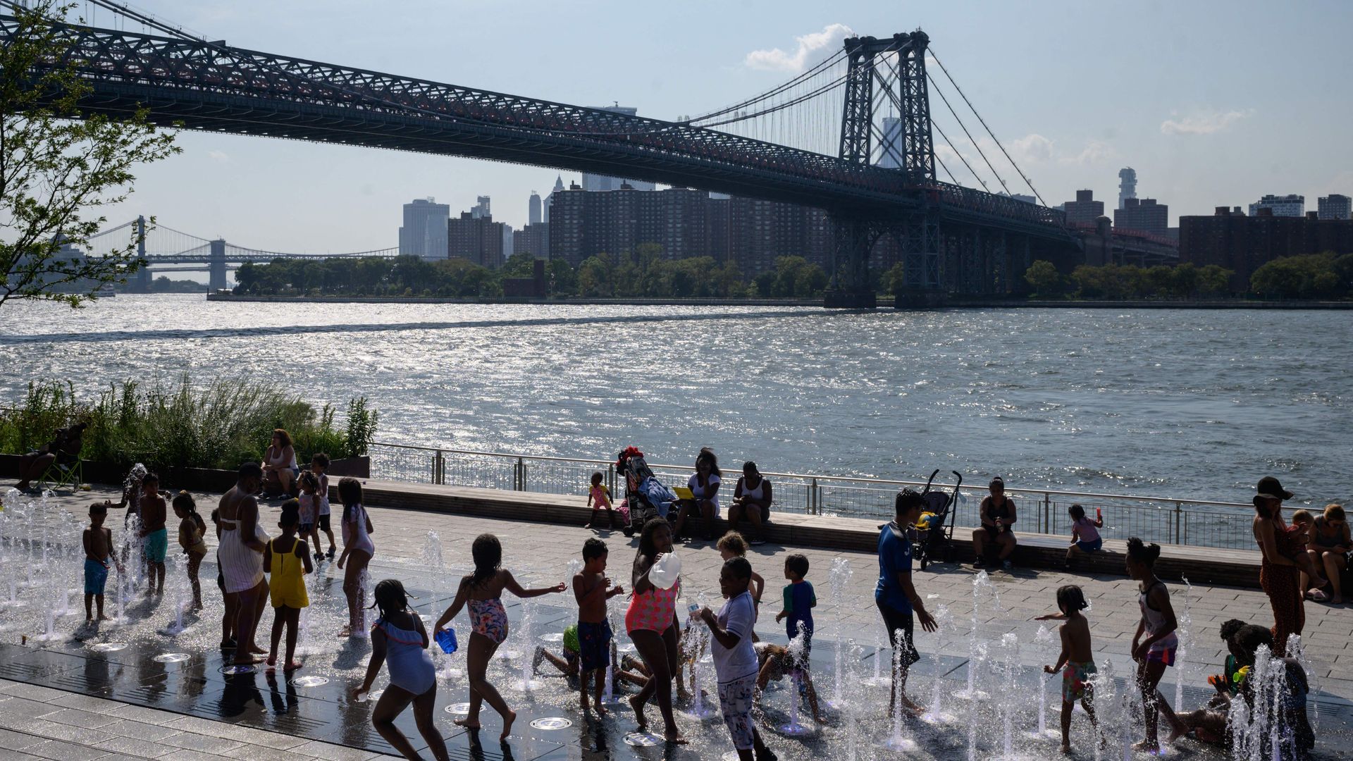 Children play in an outdoor fountain in Brooklyn, NY in August during an excessive heat warning for the city.