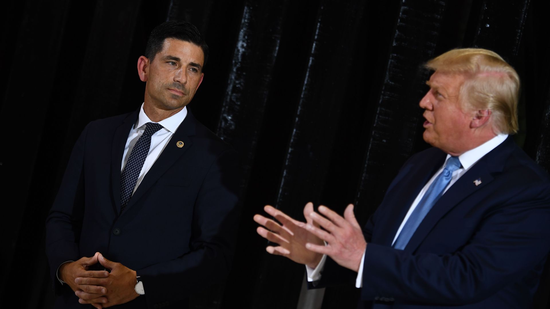 President Trump speaks as acting DHS secretary Chad Wolf watches`