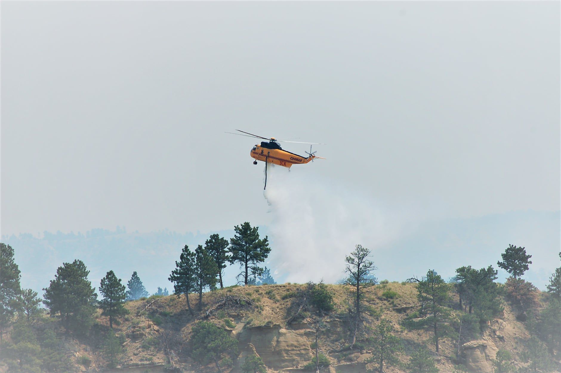 A helicopter drops water over the Devils Creek Fire in Montana July 22. 