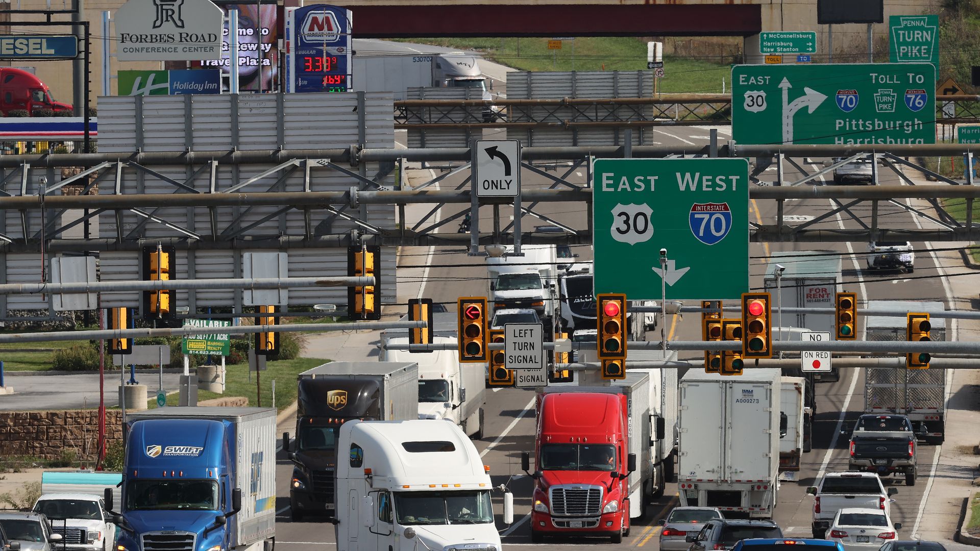 Semi-trailer trucks move along Lincoln Highway while using the indirect interchange from Interstates 70, the Pennsylvania Turnpike and U.S. Route 30 on October 14, 2021 in Breezewood, Pennsylvania