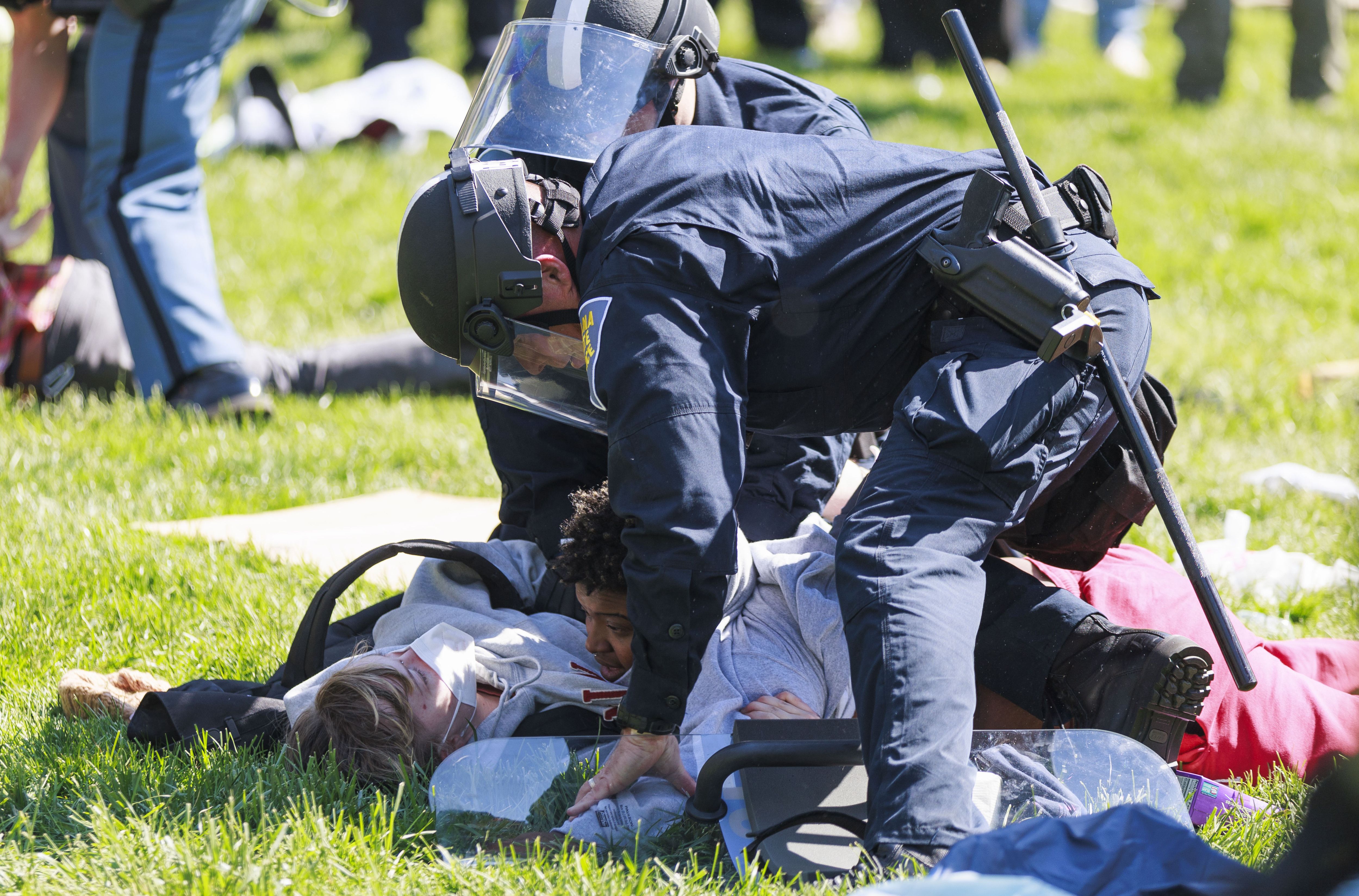 A police officer arresting protestors