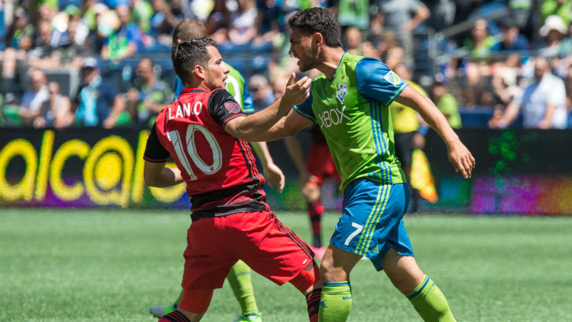 Players from the Seattle Sounders and Portland Timbers in a confrontation on the pitch. 