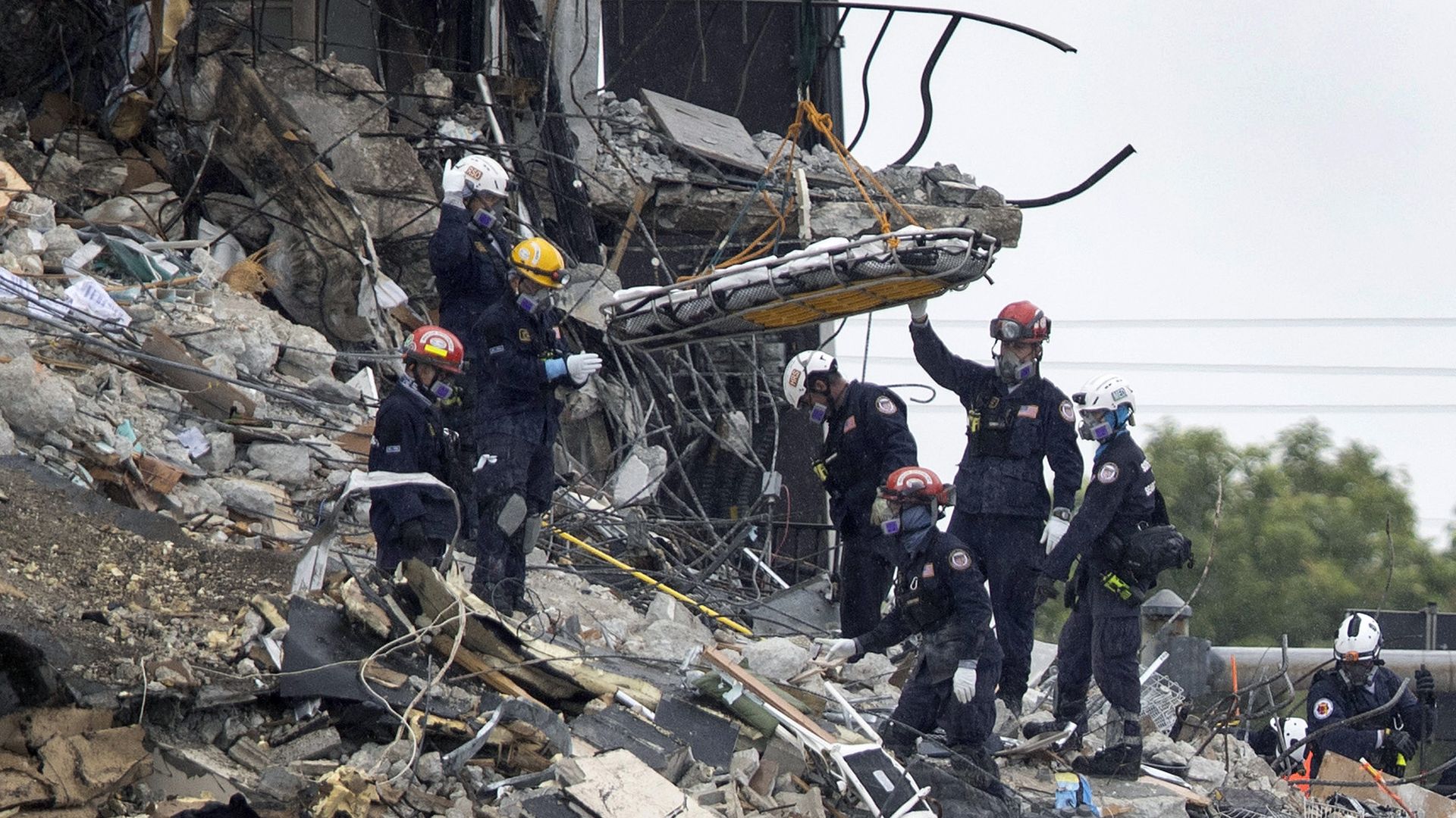 Rescue personnel remove a stretcher from the rubble of the Champlain Towers South condo building on June 28, 2021 in Surfside, Florida.