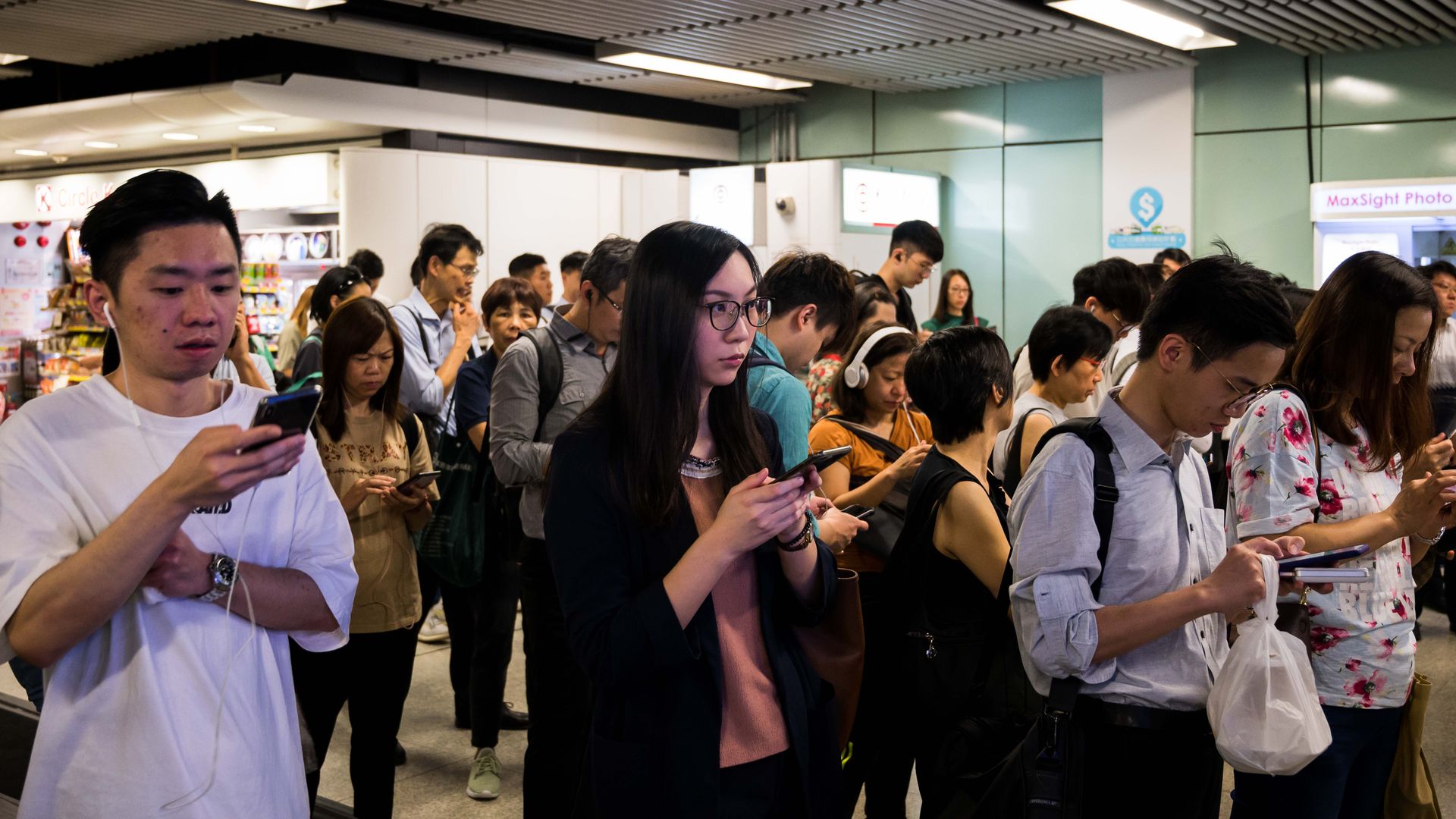 Commuters stand outside the MTR station as a group of protestor protest on August 05, 2019 in Hong Kong, China. 