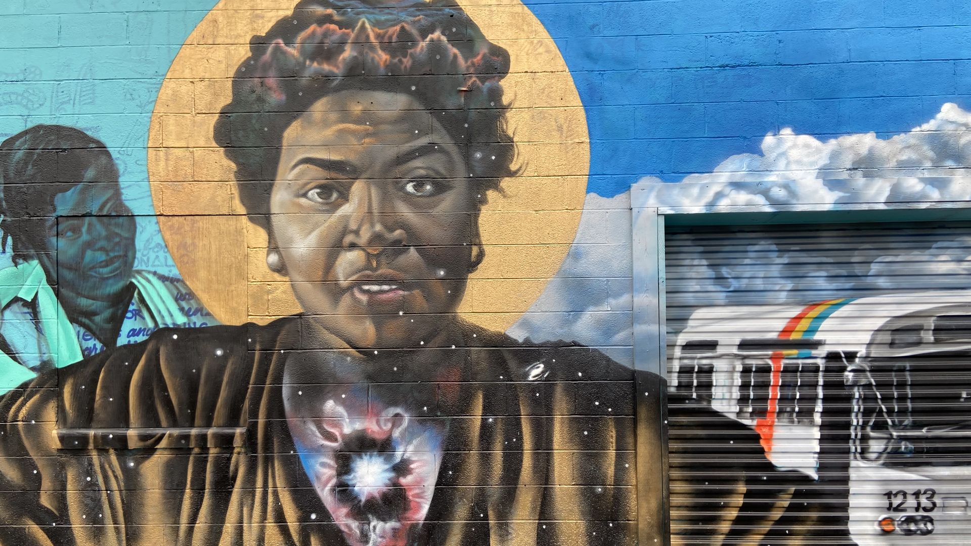 A vivid colorful mural of Dorothy Bolden, a Black domestic worker and labor organizer, surrounded by a sun and MARTA bus