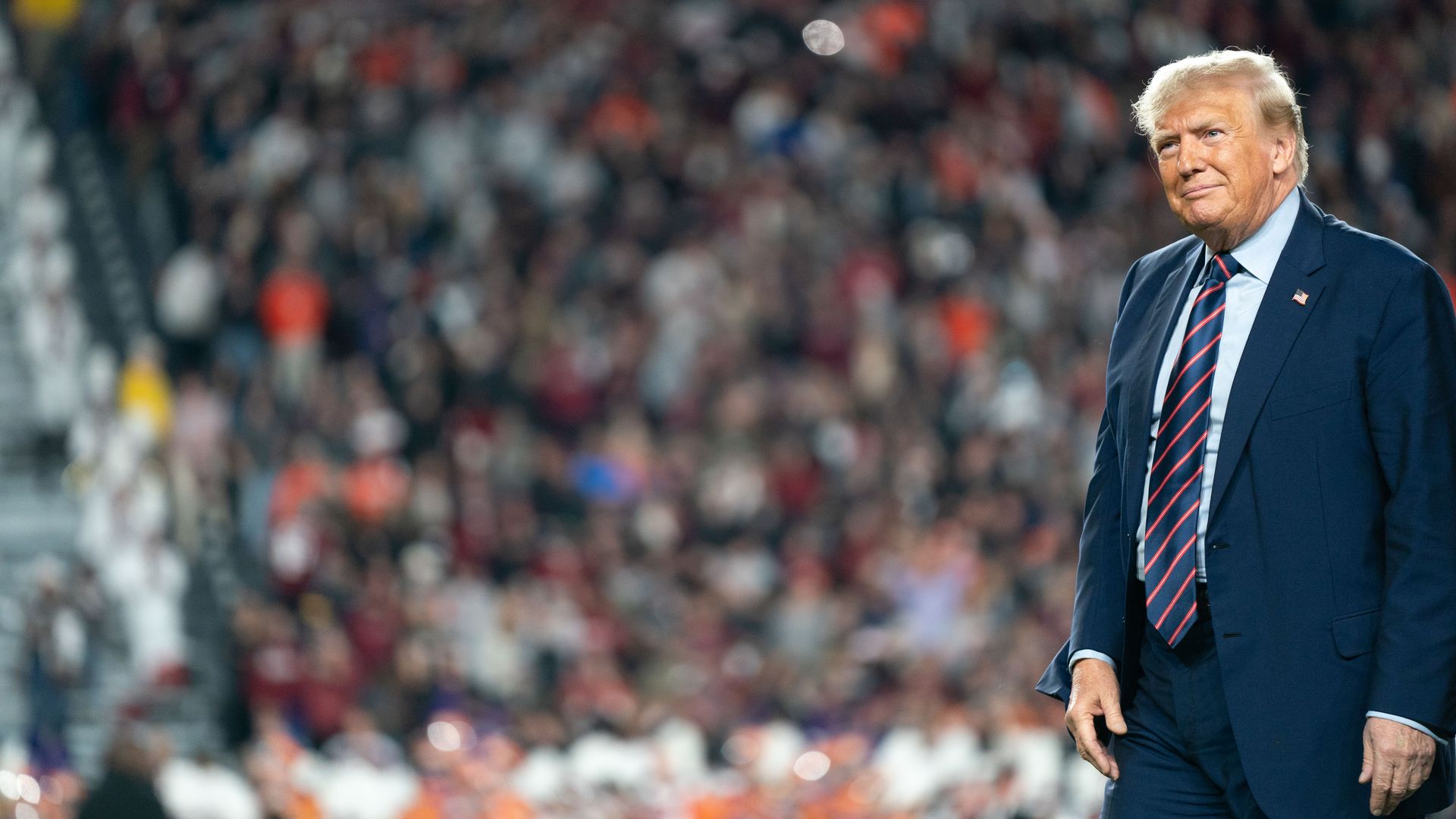 Former U.S. President Donald Trump walks across the field during halftime in the Palmetto Bowl between Clemson and South Carolina at Williams Brice Stadium on November 25, 2023 in Columbia, South Carolina. 