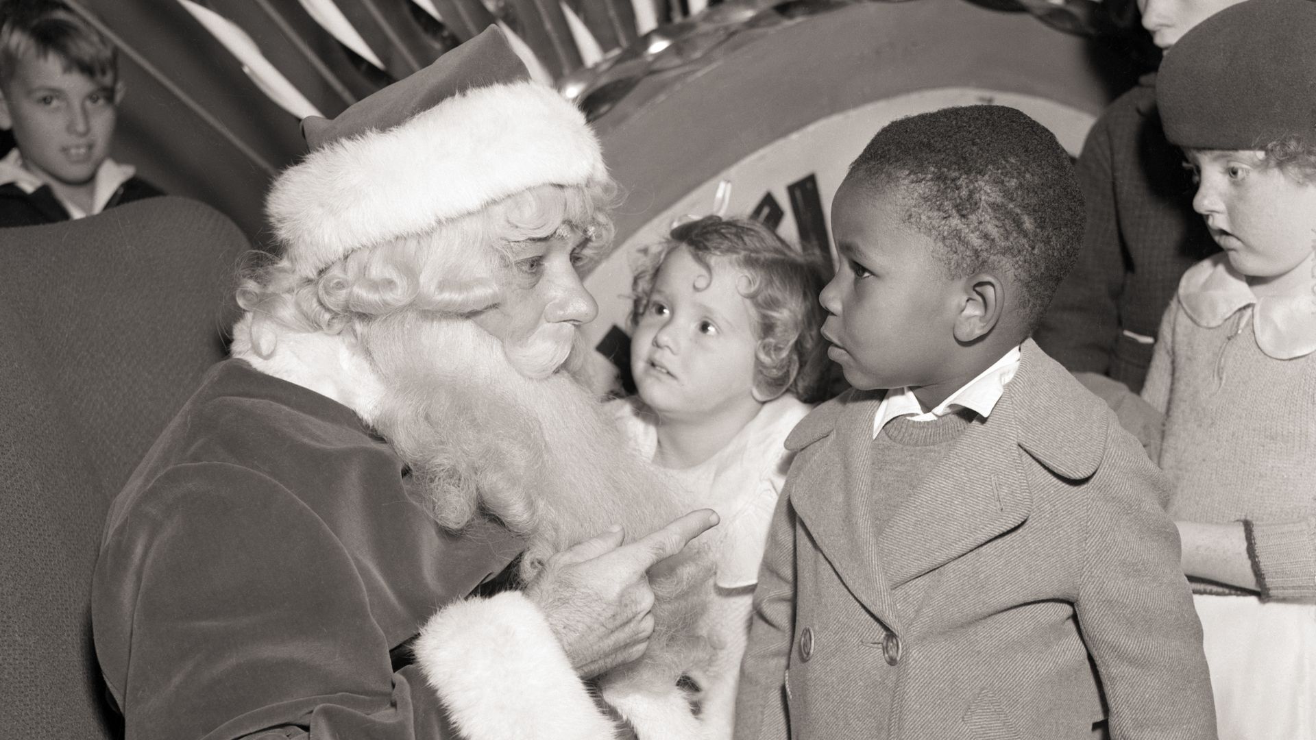 Santa Claus pays an unexpected and early visit to this youngster's home to see how things are going circa 1936.