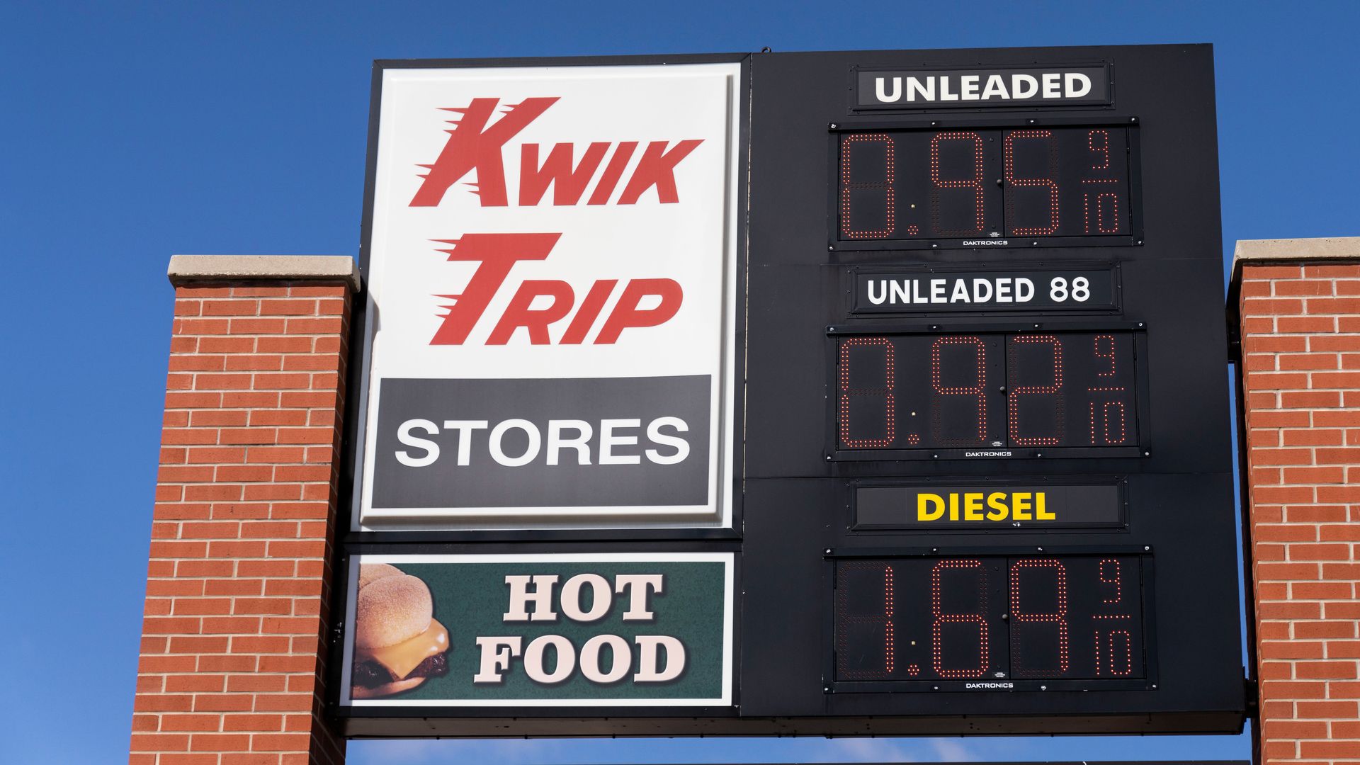 A Kwik Trip convenience store sign with gas prices and a sign for "Hot Food"