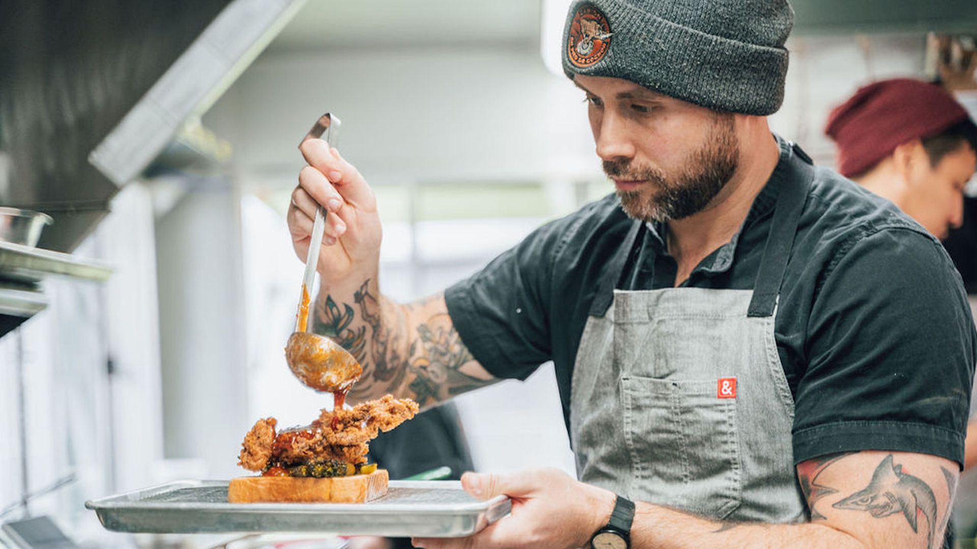 A chef prepares fried chicken at Songbird.