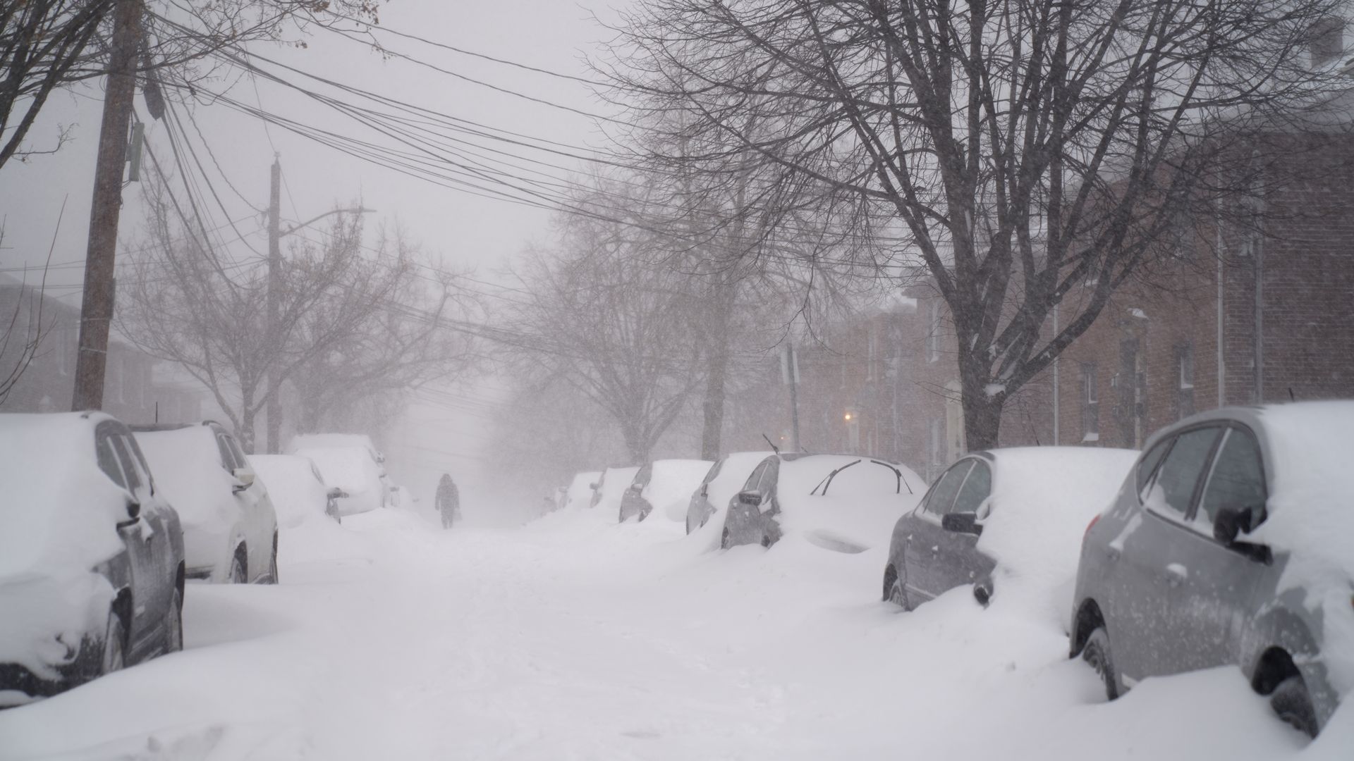 A resident walks down a street during a blizzard in Boston, Massachusetts, U.S., on Saturday