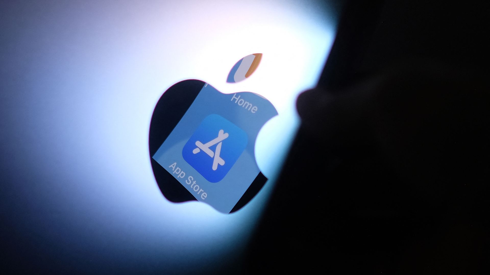 This illustration photo shows the Apple app store logo reflected from an iPhone onto the back of an iMac in Los Angeles, August 26, 2021. 