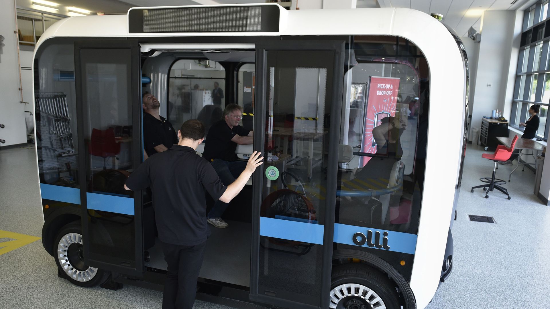 A man entering an Olli autonomous shuttle.