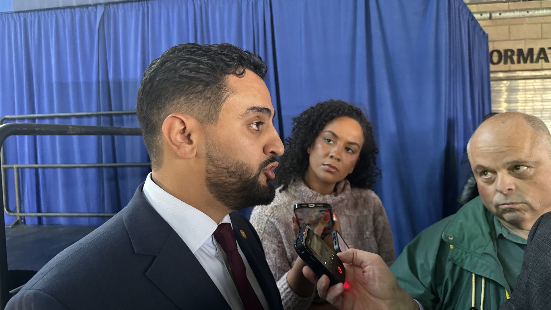 Abraham Aiyash talks to reporters on Tuesday, Nov. 28 at Eastern Market after a bill signing event with the governor. Photo: Samuel Robinson/Axios