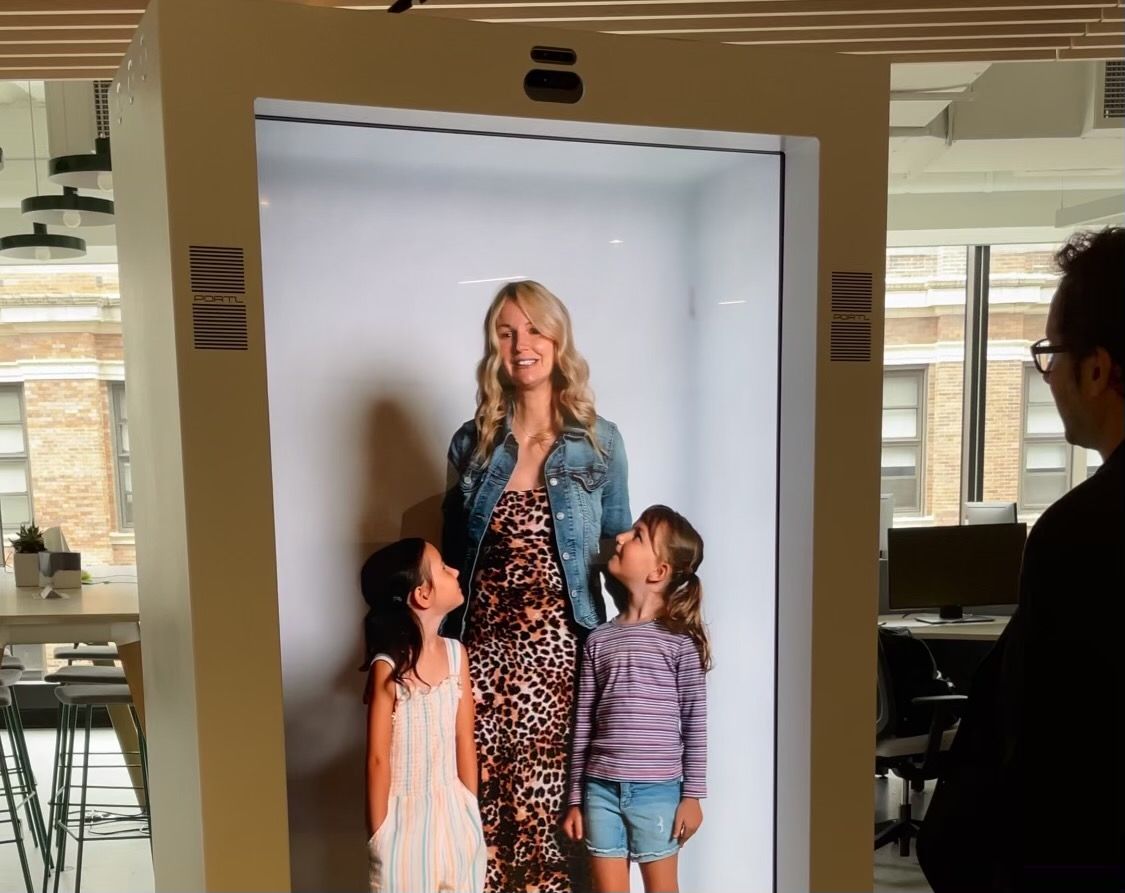 The wife and children of PORTL CEO David Nussbaum seen in a PORTL heleportation booth.