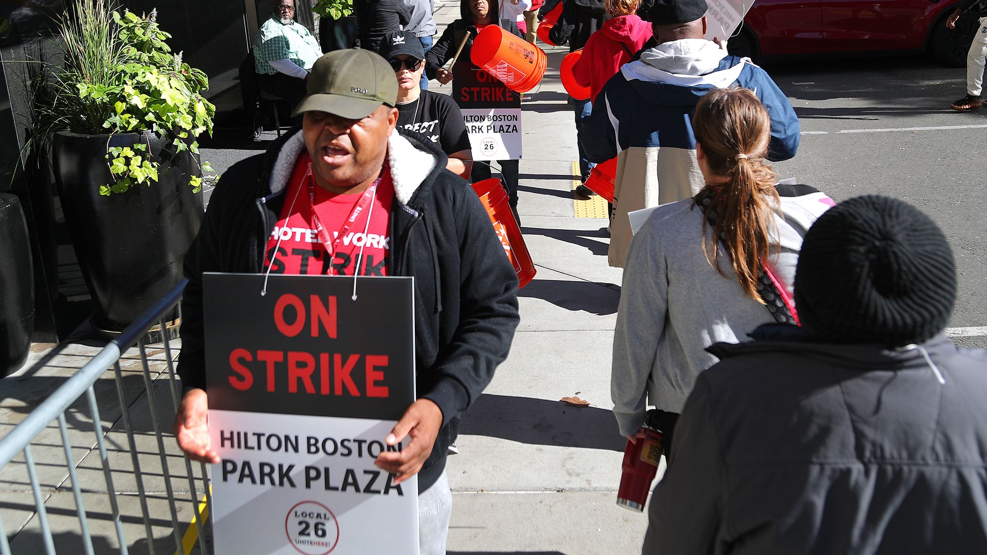 Hilton Boston Park Plaza hotel workers hold signs and walk around as they're on strike.