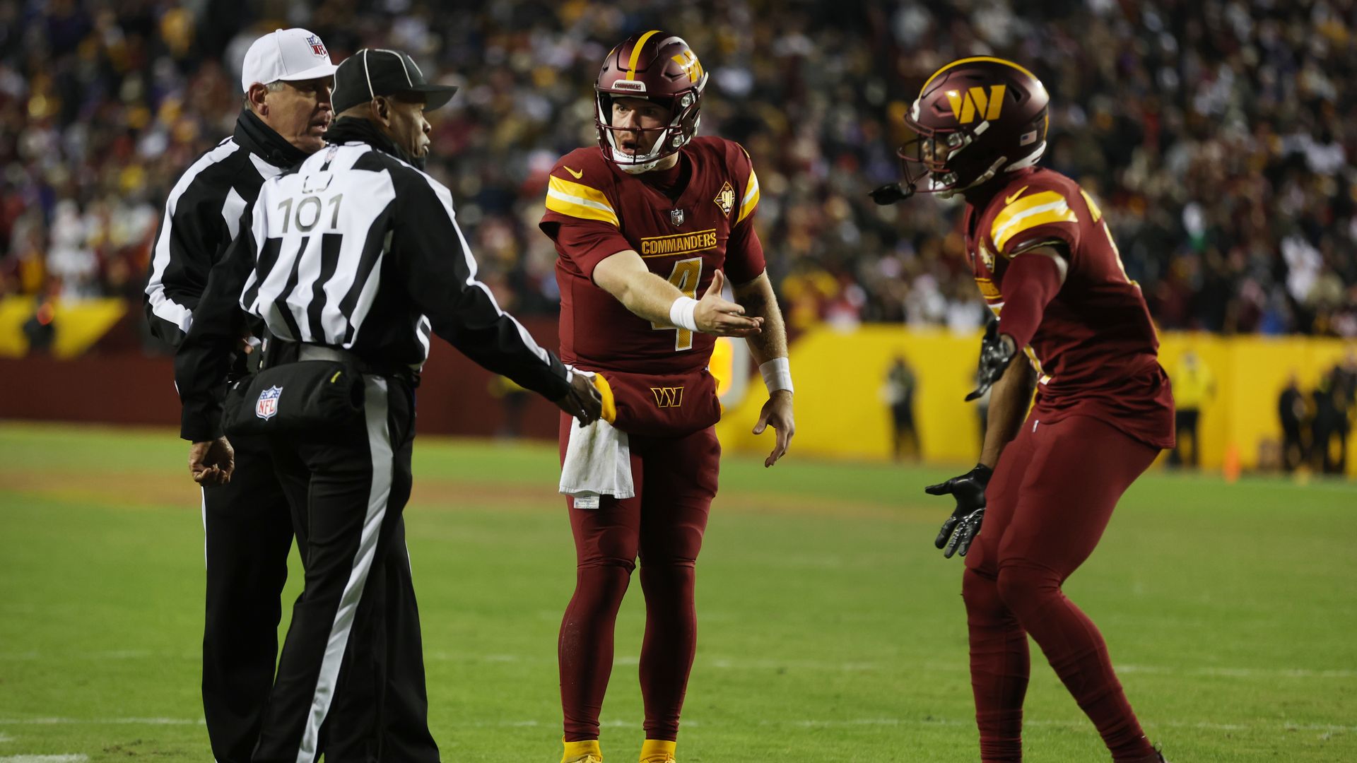 Taylor Heinicke argues with NFL officials on the field