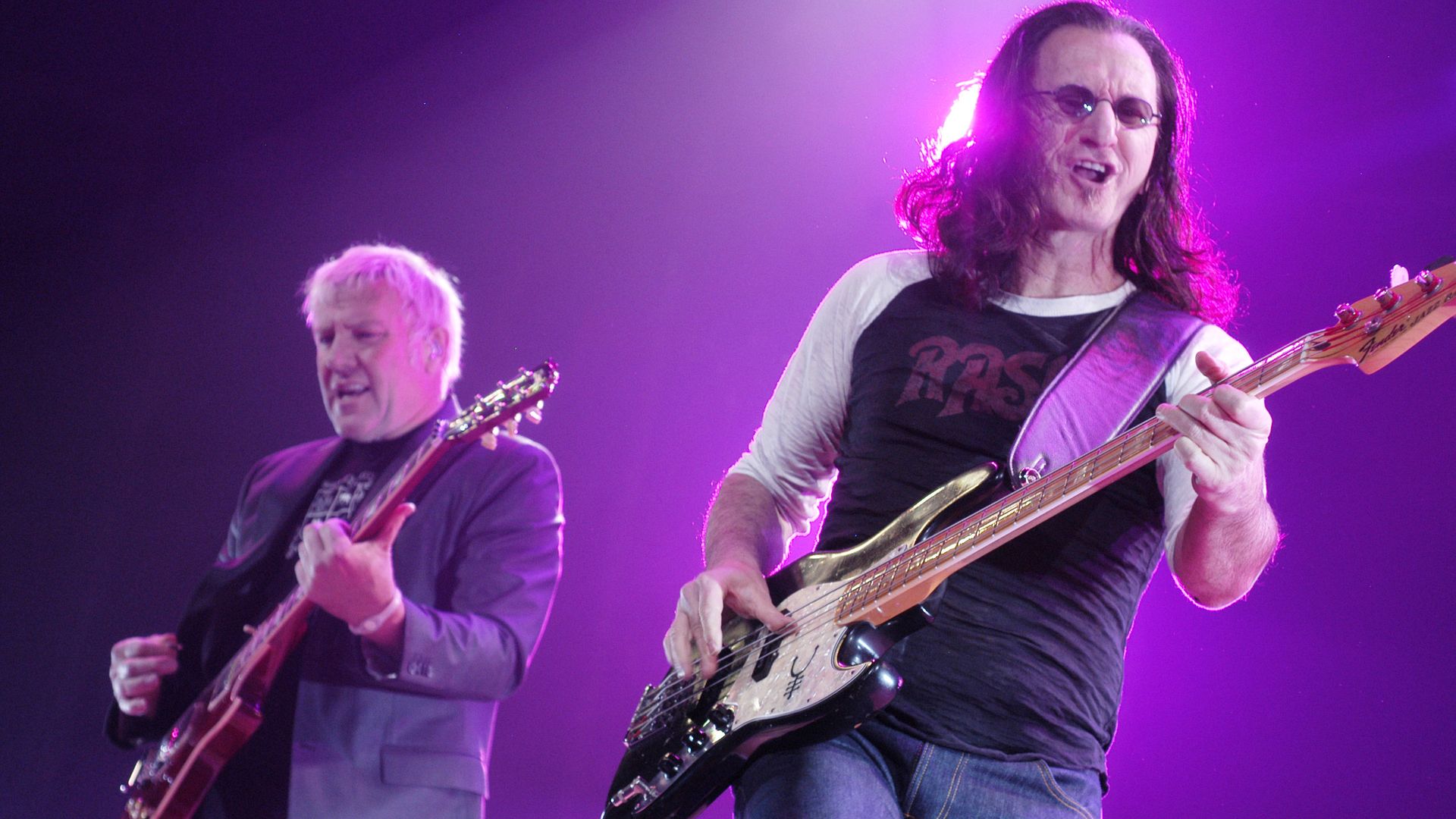 Members of Rush perform on stage. 