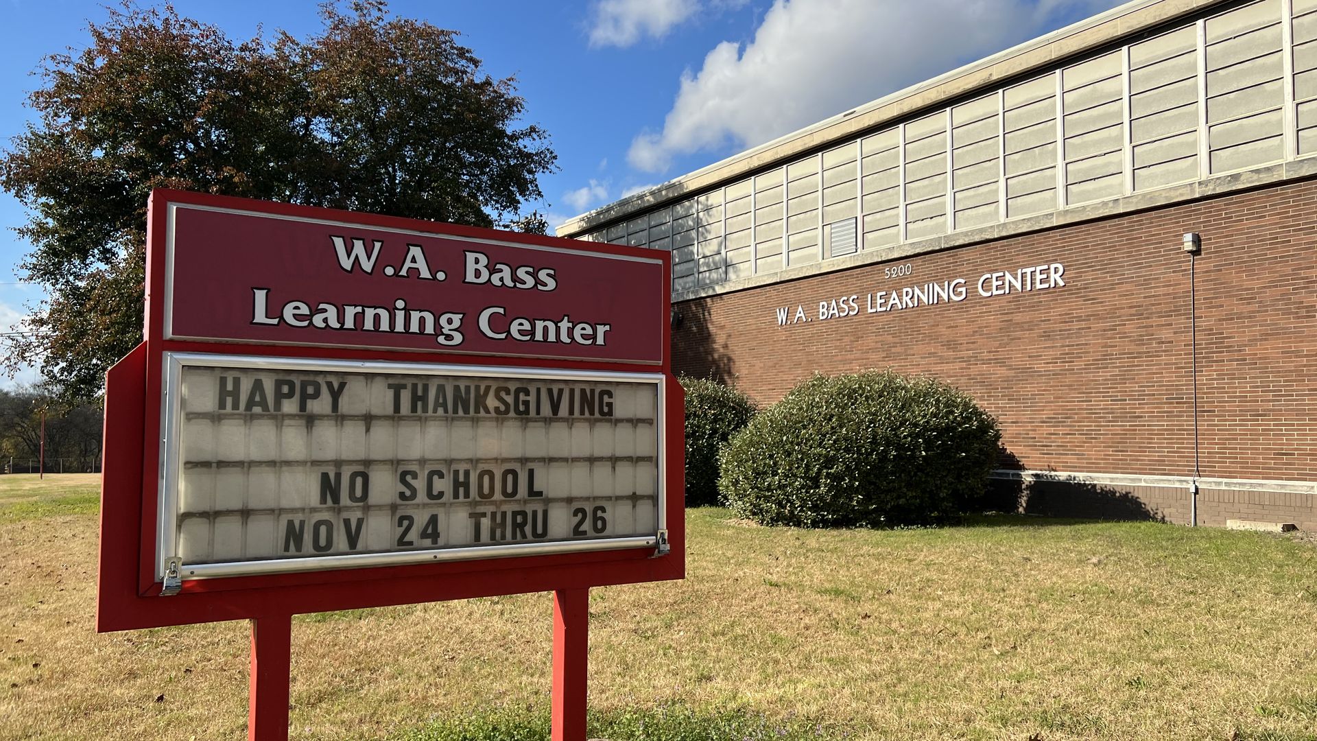 Image of WA Bass school with a sign in the front of the building.
