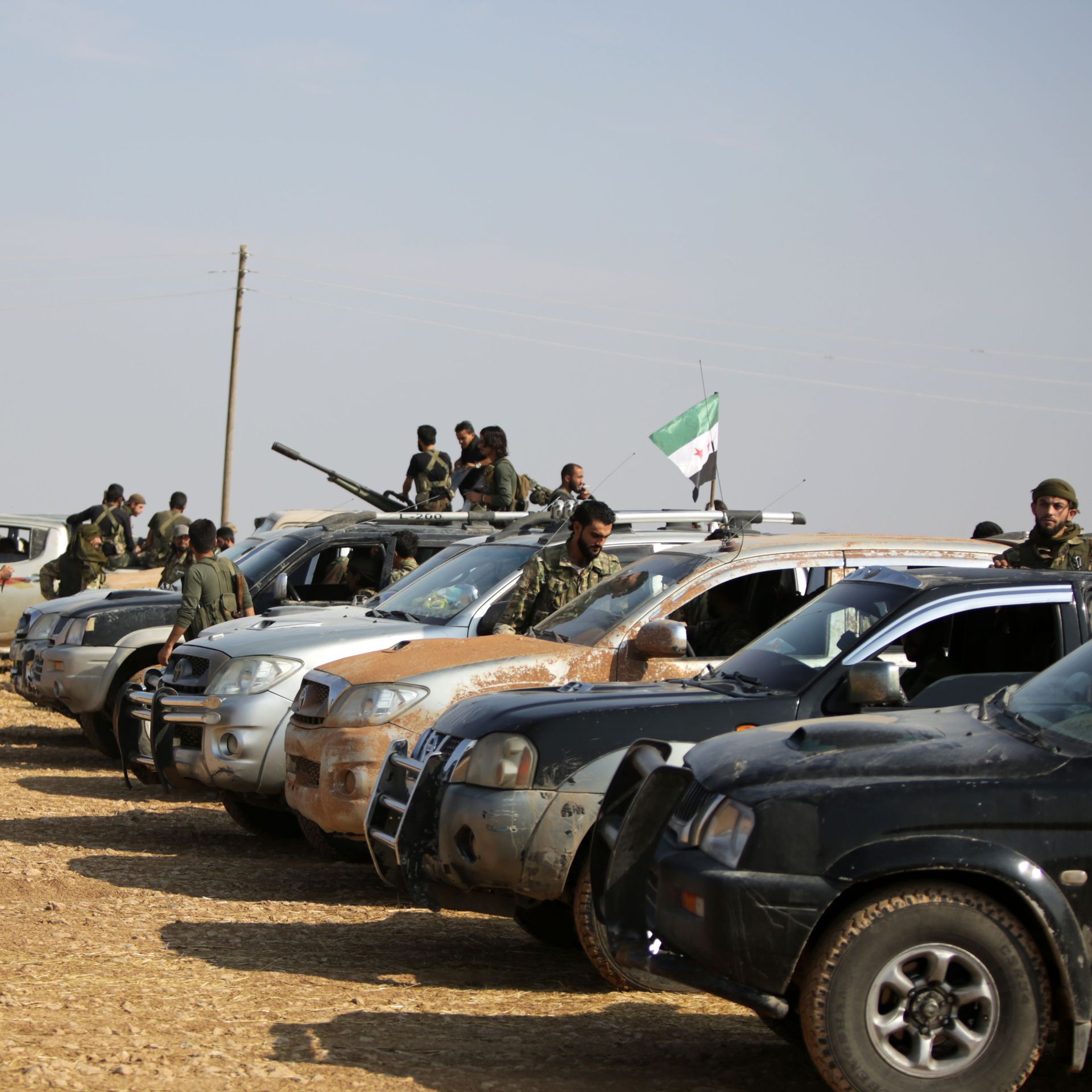 fighters in and around a small fleet of cars and trucks