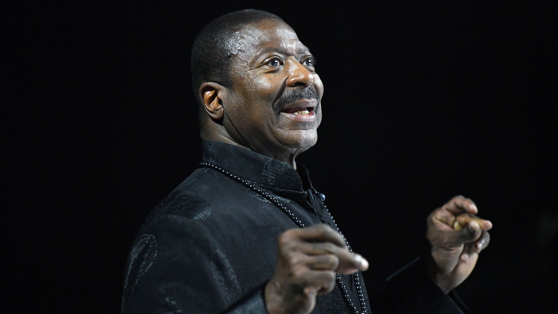 Gary Hines wears a black shirt on stage 