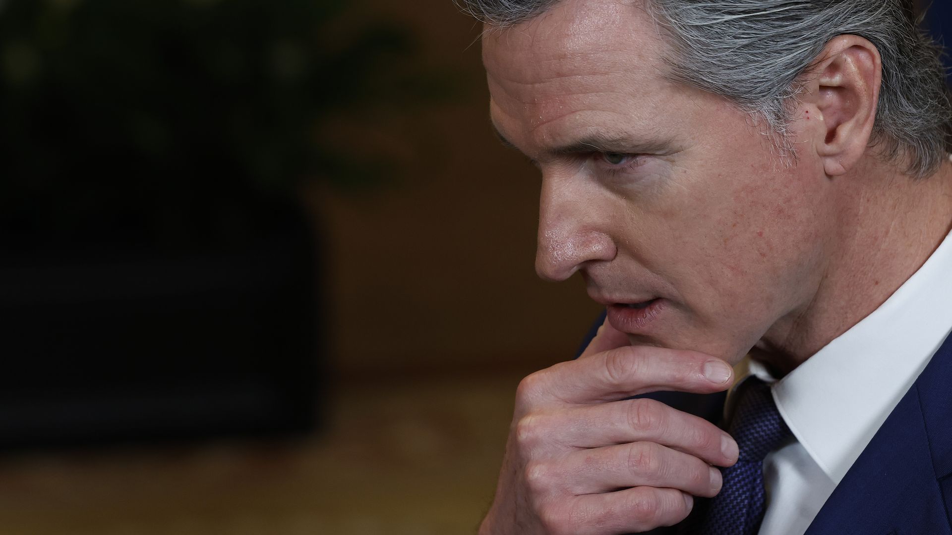 Photo of Gavin Newsom resting his hand on his chin
