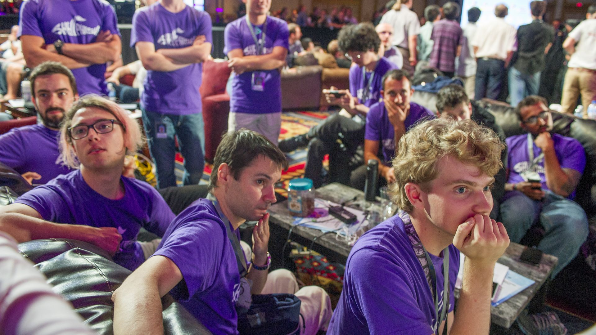 Hackers watch their system perform in a competition