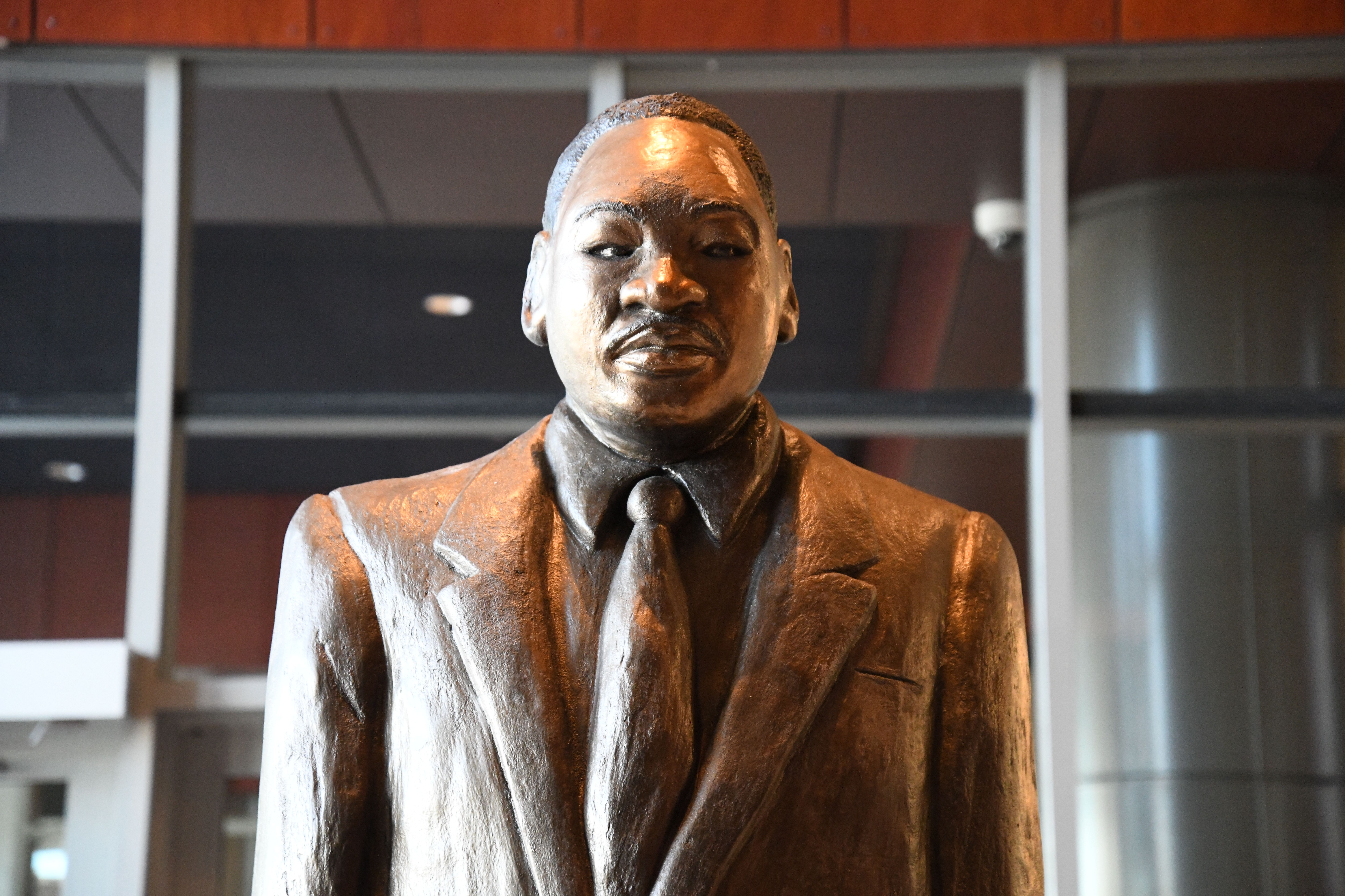 Photo shows a cement statue of Martin Luther King Jr.