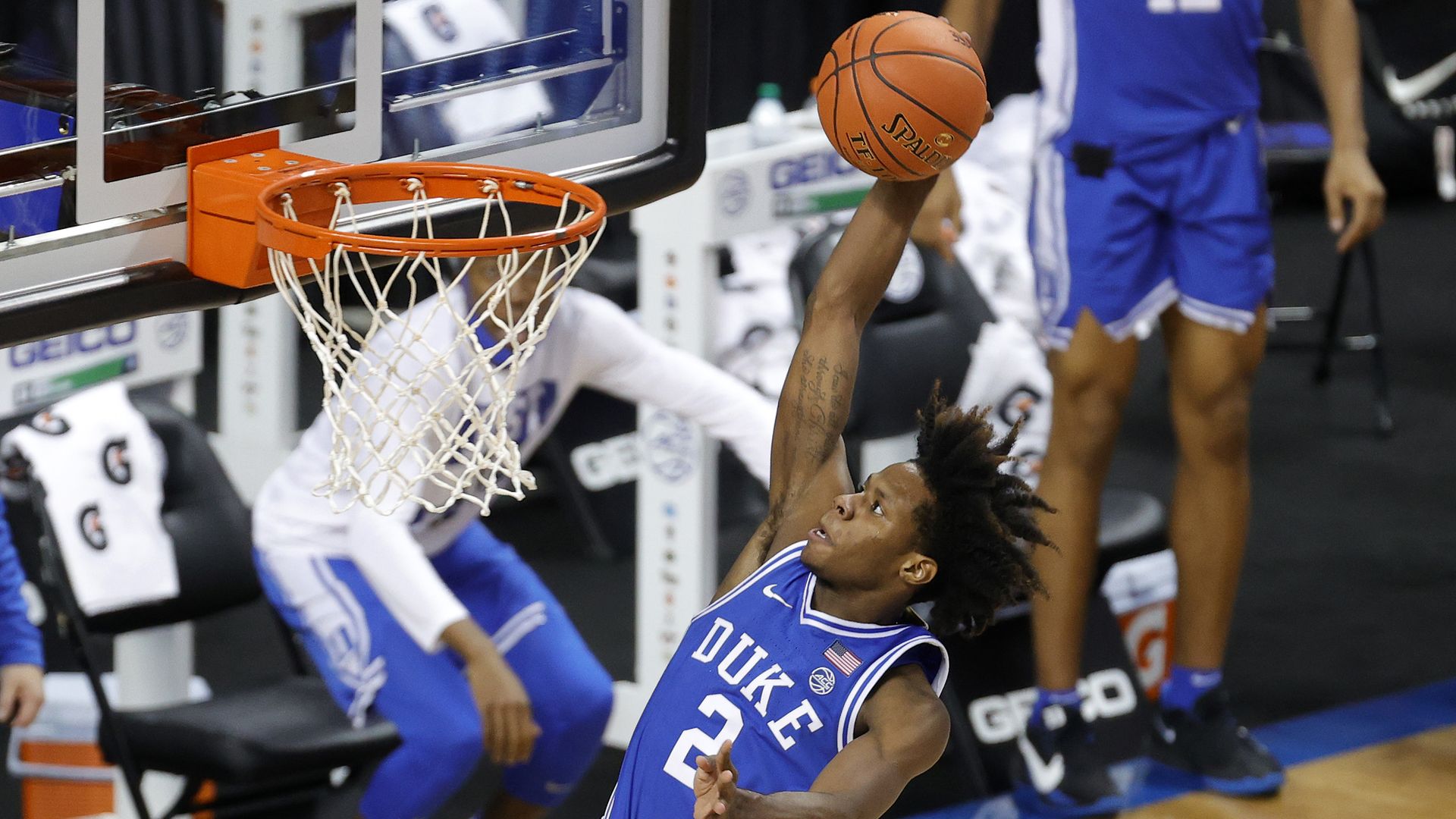 Duke player dunks the basketball through the hoop during a game