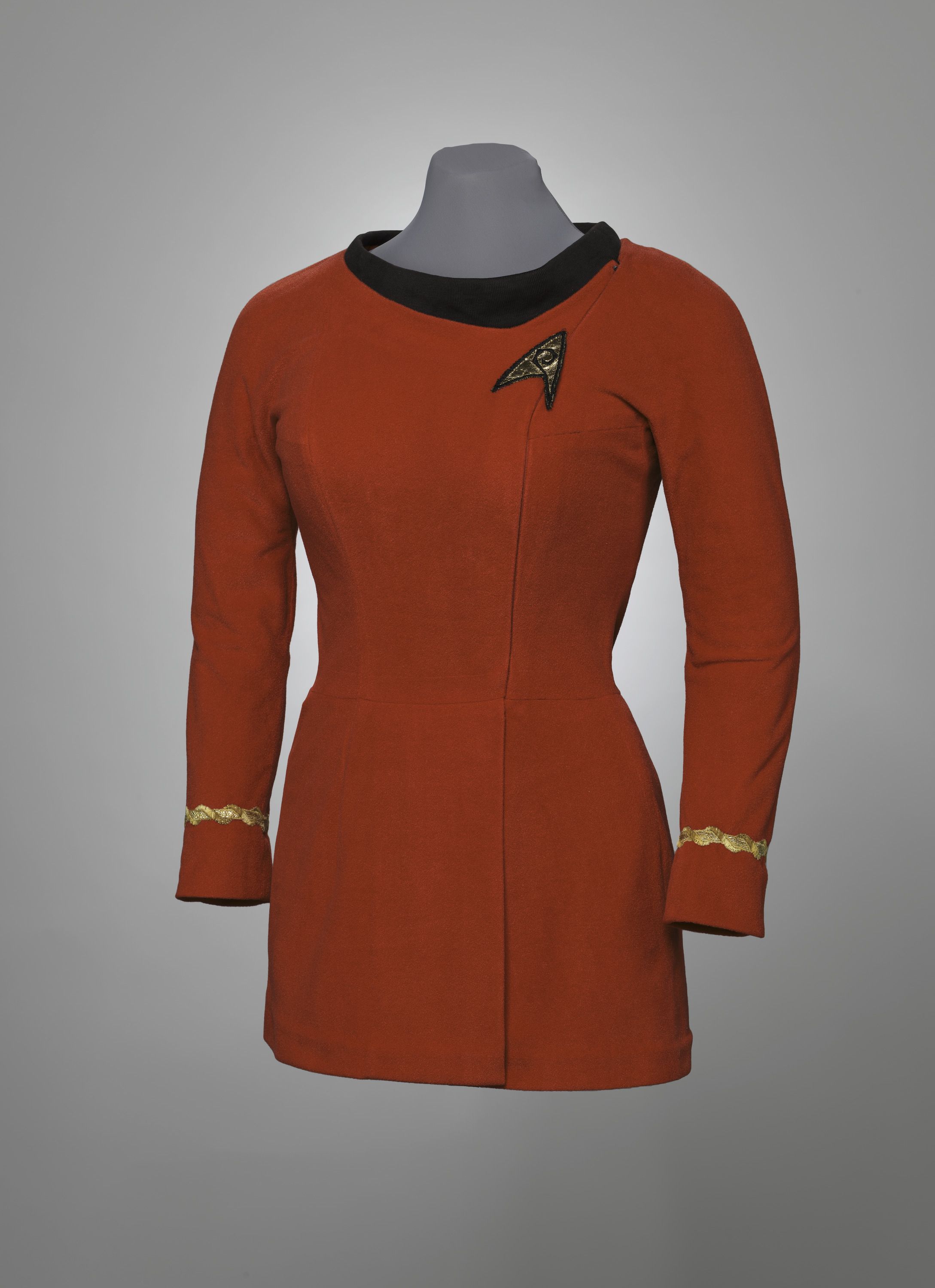 A red suit top with a black color and a Star Trek logo on the breast.