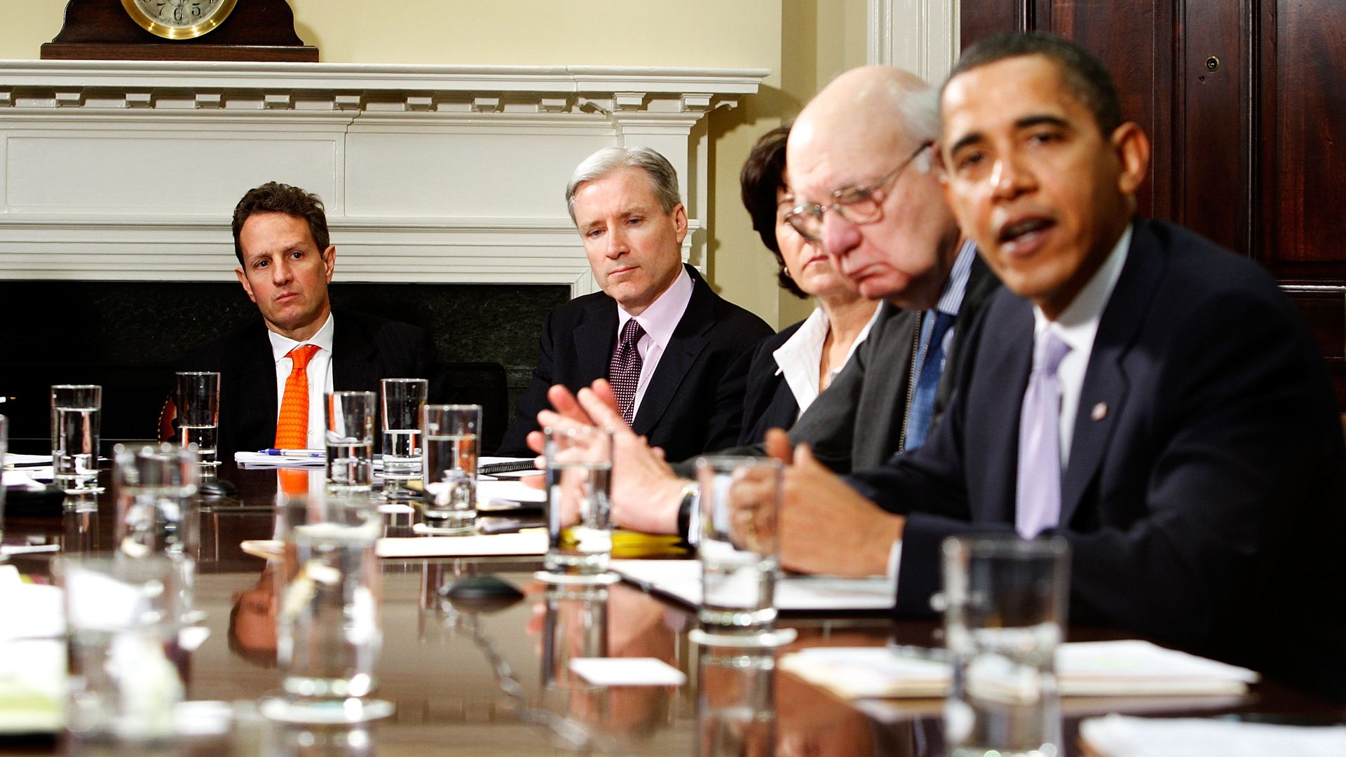 Mark Gallogly is seen sitting a table with President Obama.