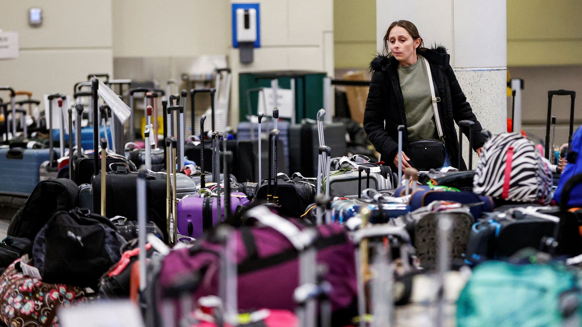 A Southwest Airlines traveler looks for her baggage at Chicago Midway International Airport on Dec. 27.