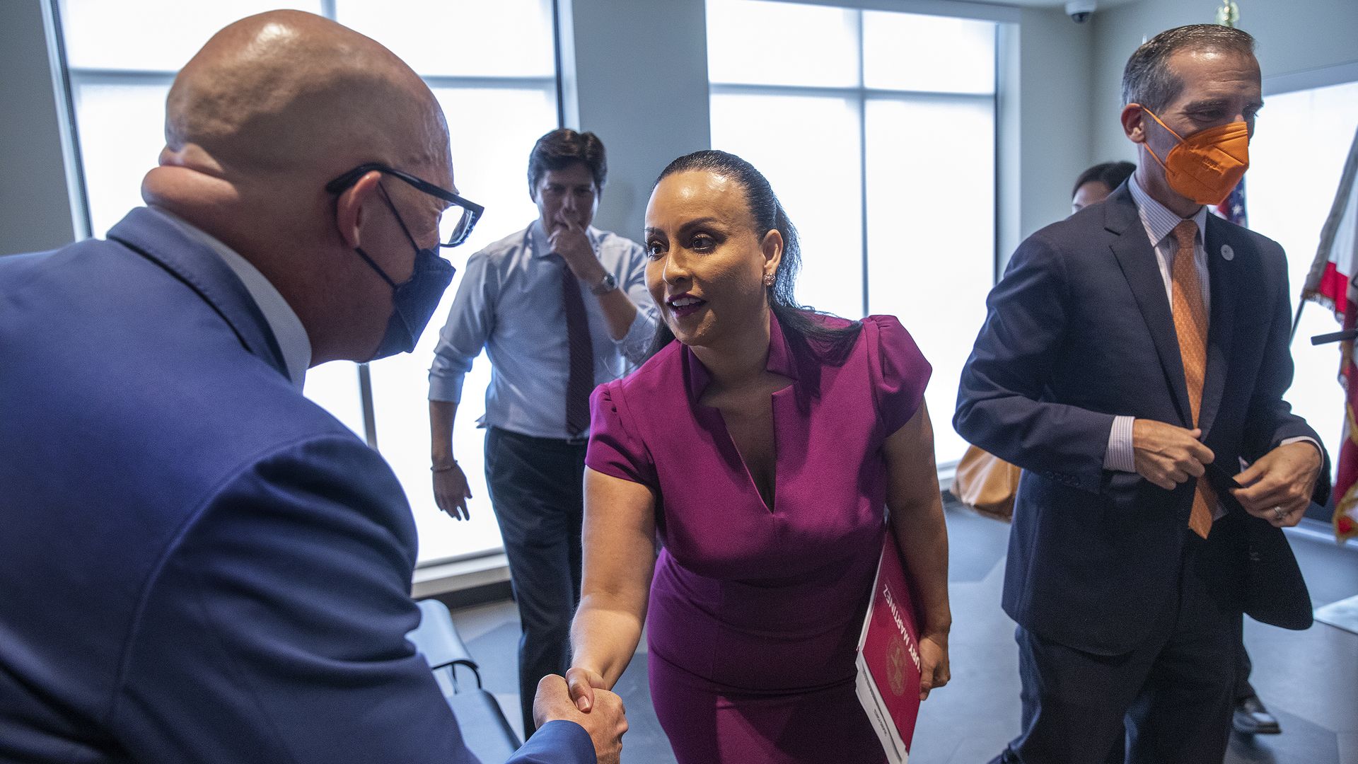 Matt Hewumhofer, left, an attorney representing L.A. Alliance, shakes hands with Los Angeles City Council President Nury Martinez