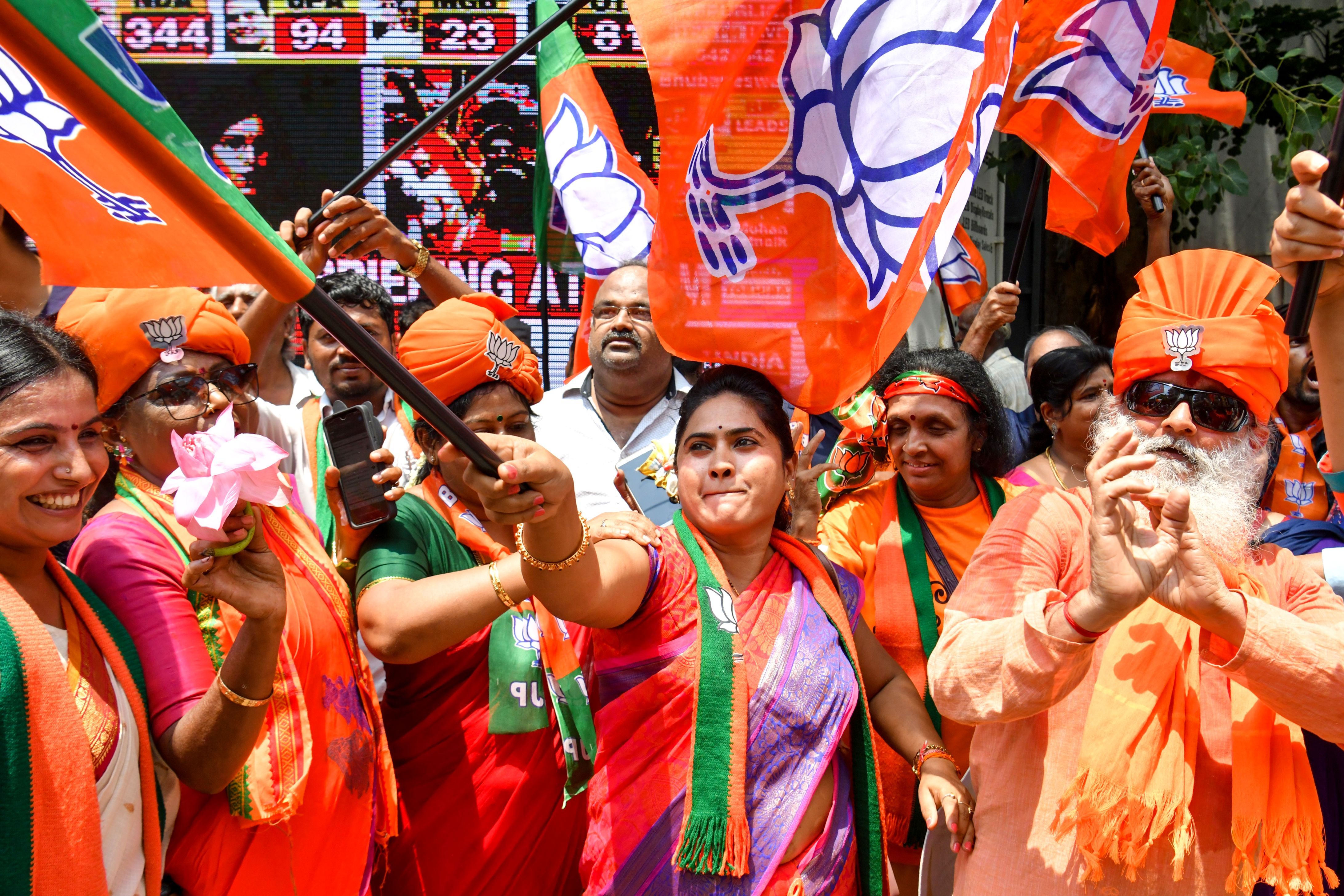 ndian supporters and party workers of Bharatiya Janata Party (BJP) dance and hold flags as they celebrate on the vote results day for India's general election in Bangalore on May 23, 2019. 
